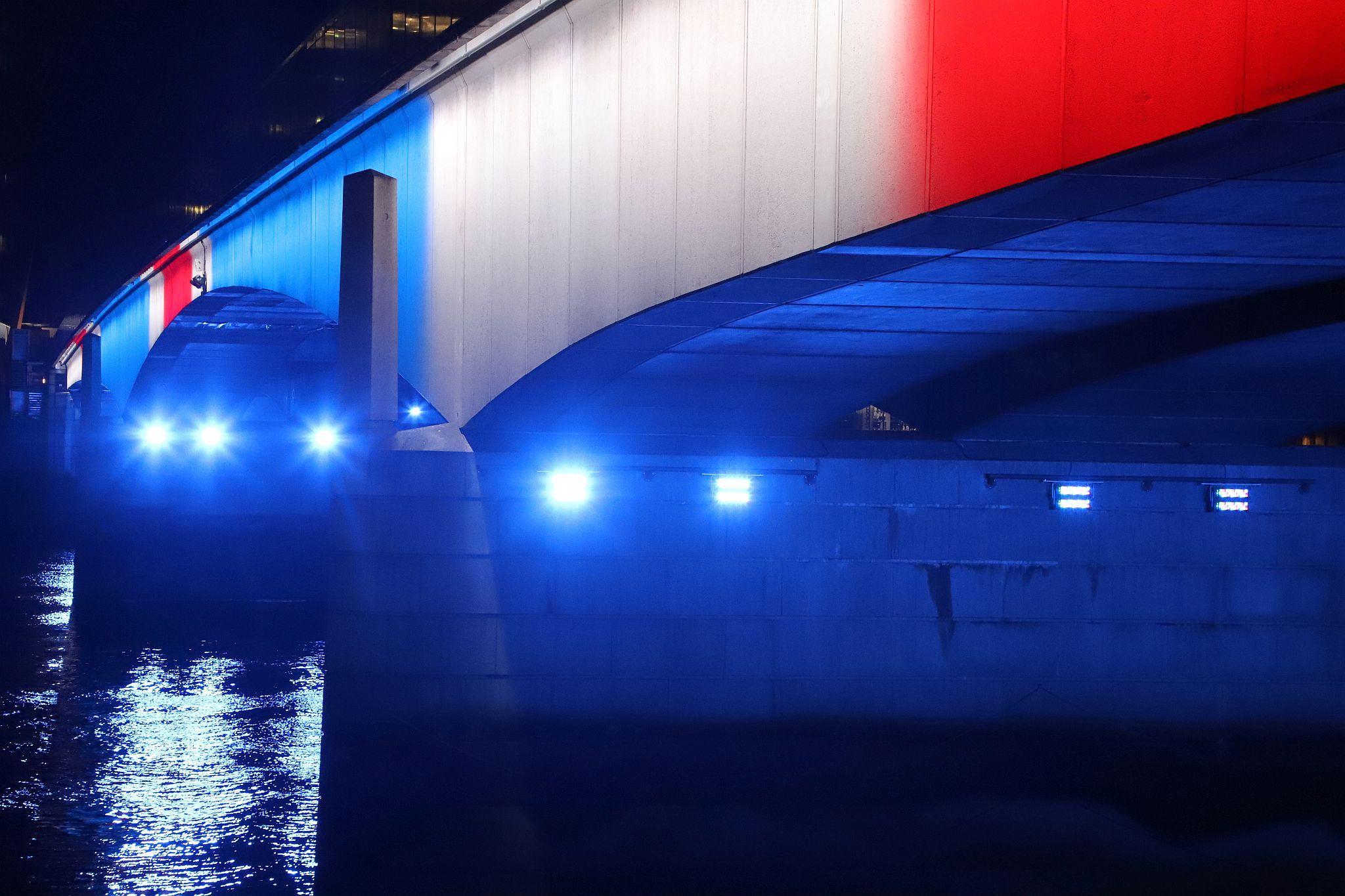 London Bridge lit red, white and blue to mark the Coronation of King Charles III and Queen Camilla. Photo taken 07-May-2023. London.