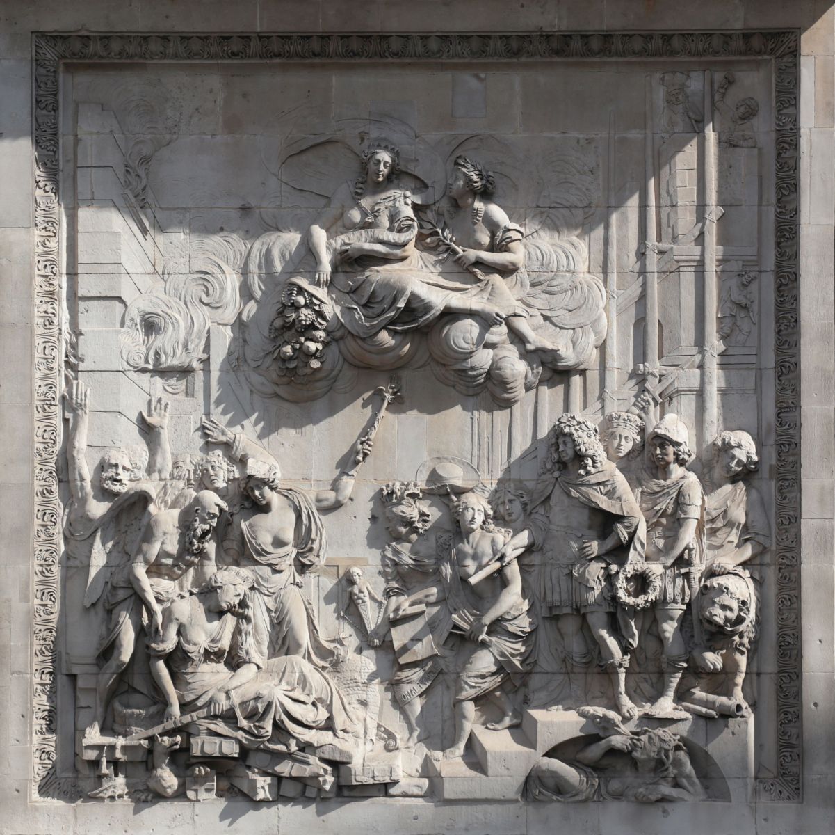 The Cibber sculpture at the base of the Monument in sunshine