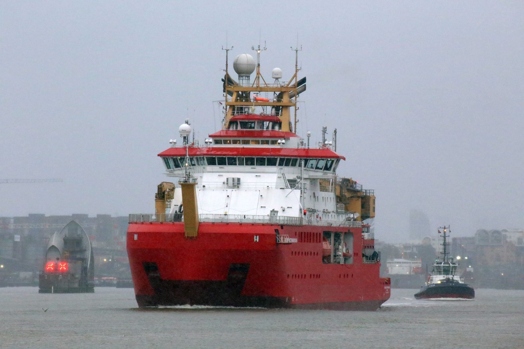 RRS Sir David Attenborough passing Woolwich, London on the River Thames heading out to sea.