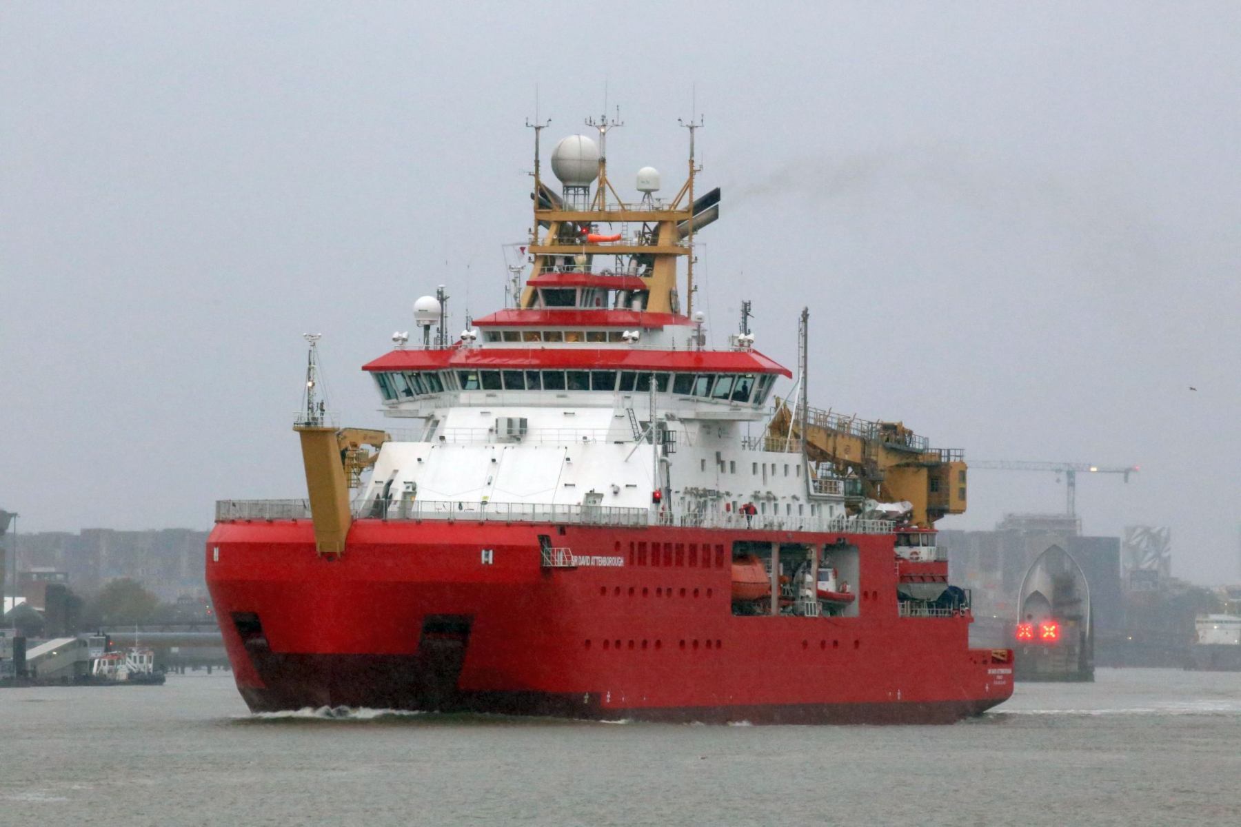 RRS Sir David Attenborough passing Woolwich, London on the River Thames heading out to sea.