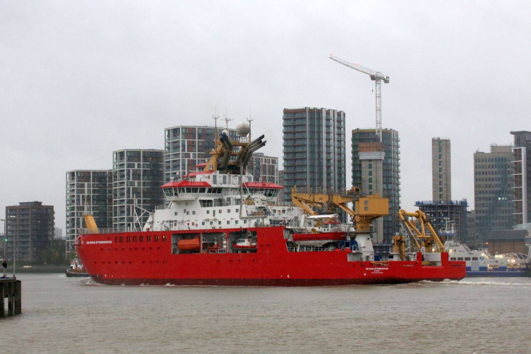 RRS Sir David Attenborough passing Woolwich, London on the River Thames heading out to sea.