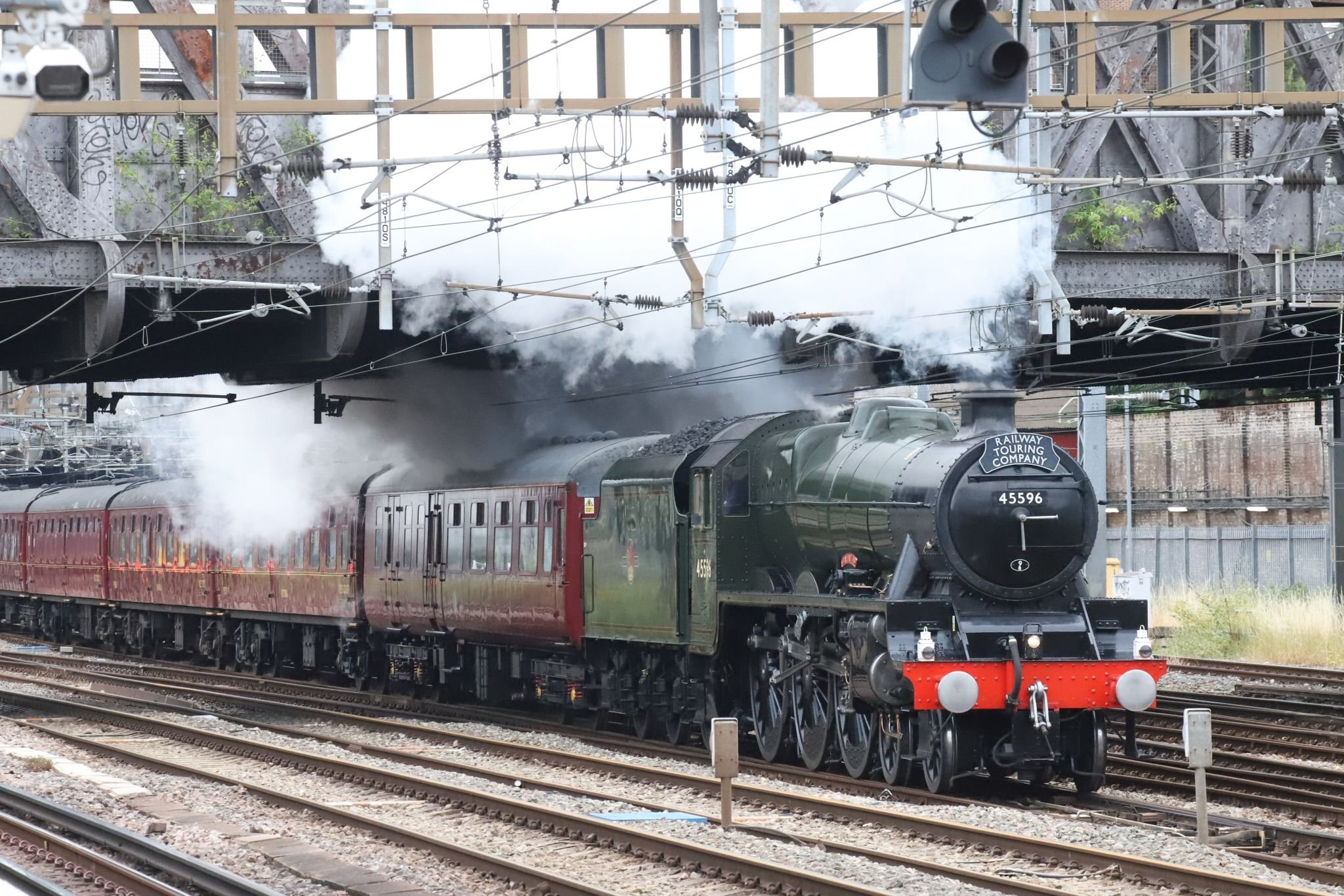 Ranelagh Bridge. LMS Jubilee class steam locomotive 45596 "Bahamas" in BR livery passing Royal Oak London Underground railway station at 07:05 on 22-Jul-2022 hauling The Railway Touring Company's "West Somerset Steam Express" to Minehead.