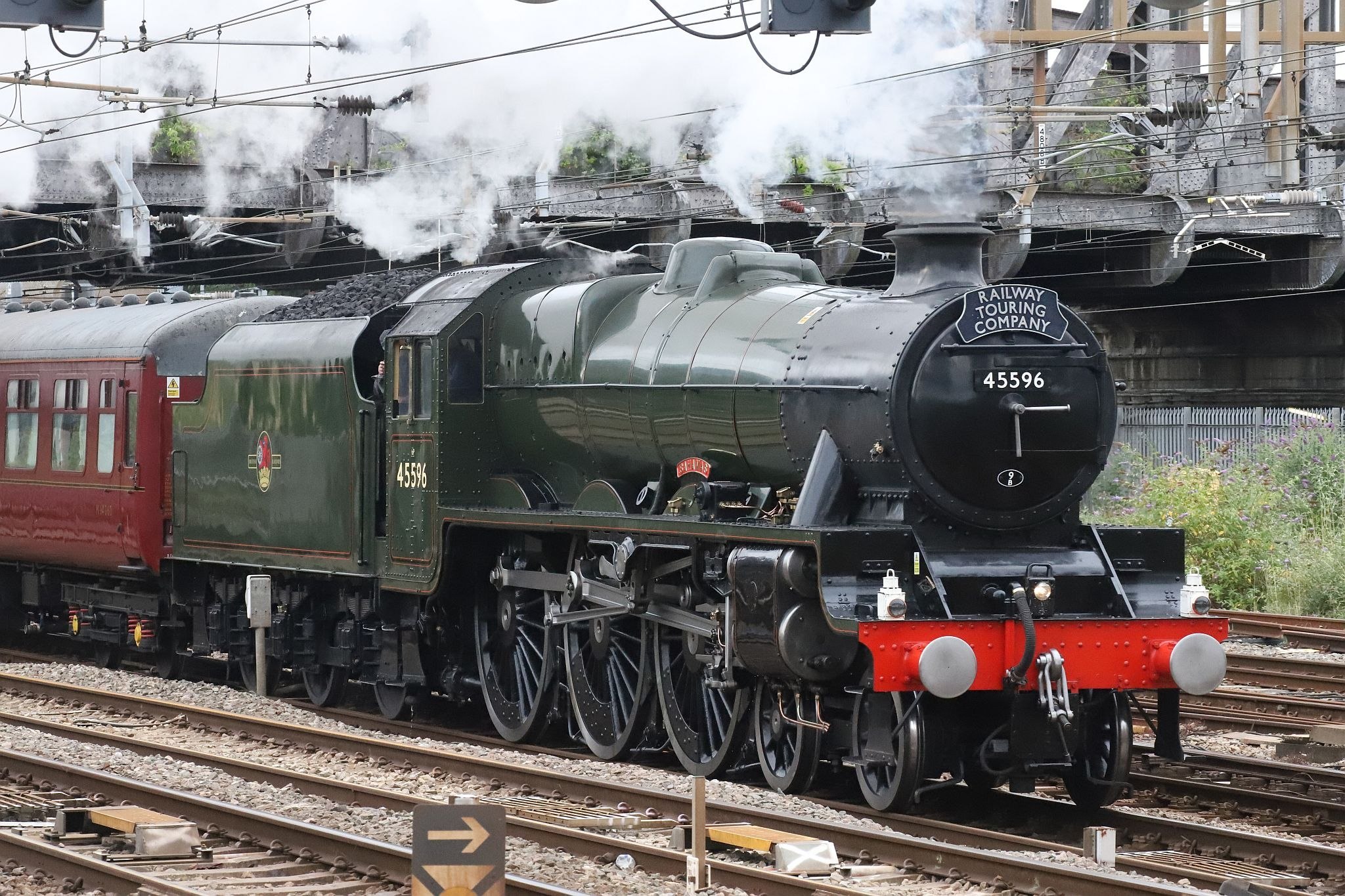 LMS Jubilee class steam locomotive 45596 "Bahamas" in BR livery passing Royal Oak London Underground railway station at 07:05 on 22-Jul-2022 hauling The Railway Touring Company's "West Somerset Steam Express" to Minehead.