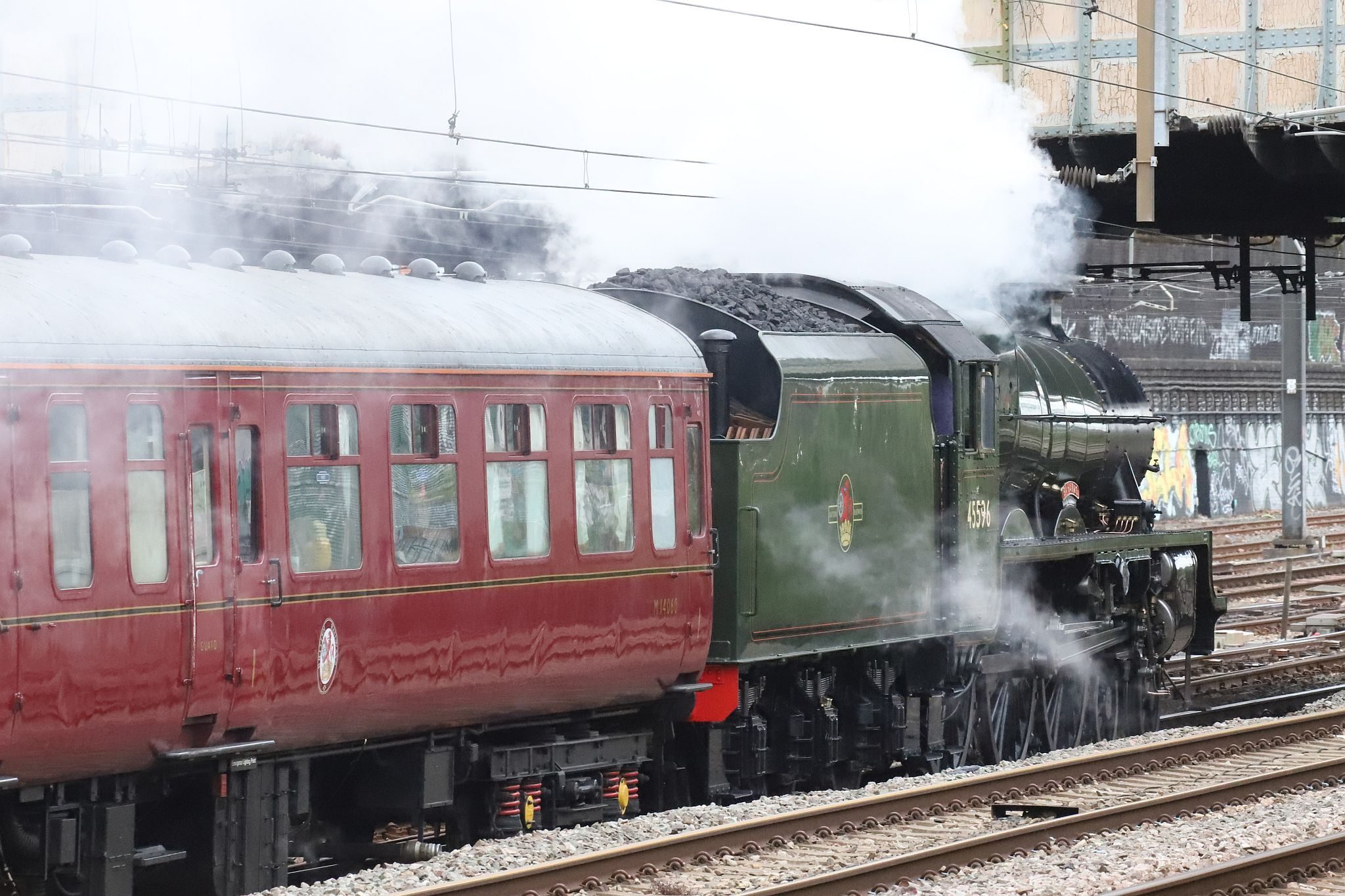 Lord Hills Bridge. LMS Jubilee class steam locomotive 45596 "Bahamas" in BR livery passing Royal Oak London Underground railway station at 07:05 on 22-Jul-2022 hauling The Railway Touring Company's "West Somerset Steam Express" to Minehead.