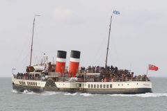 Paddle Steamer Waverley going away from the camera in the Thames estuary at speed with the Red Ensign flying