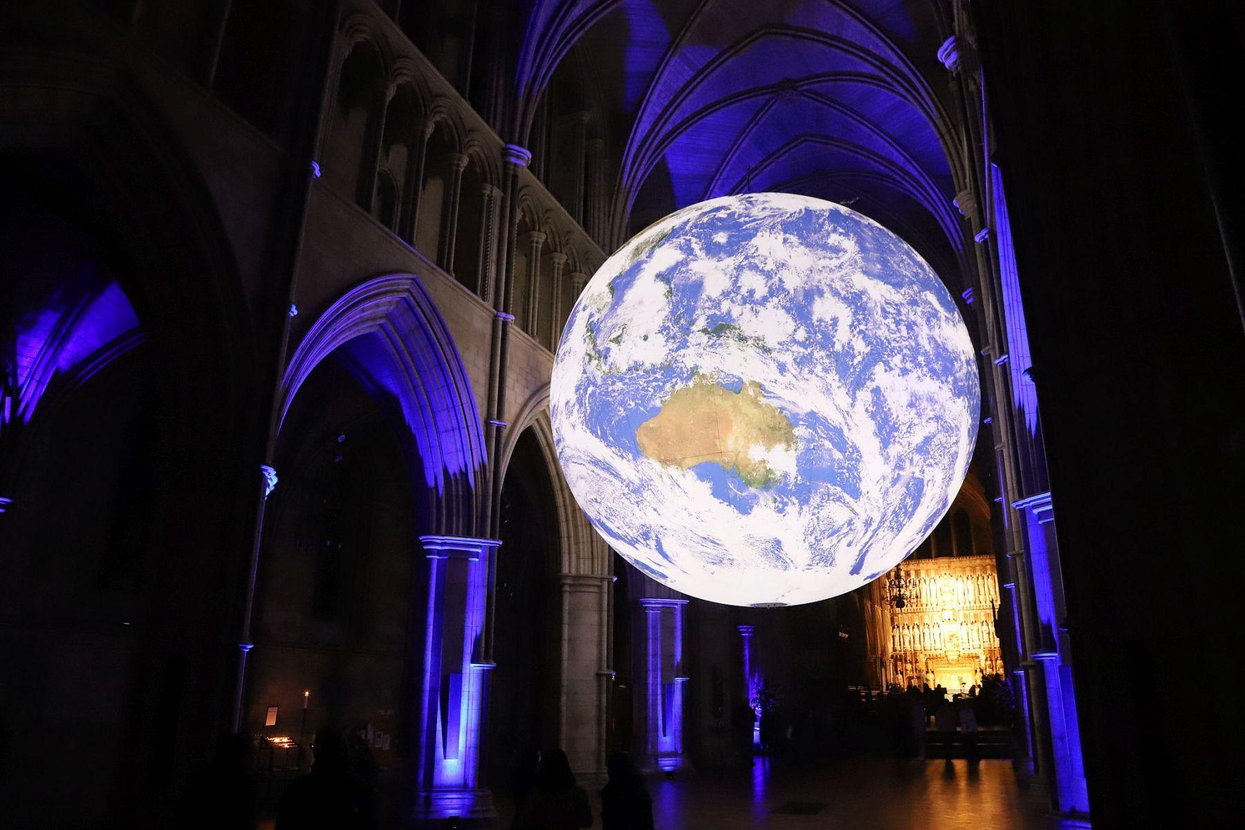 Gaia Earth by Luke Jerram at Southwark Cathedral in October 2022, seen at night