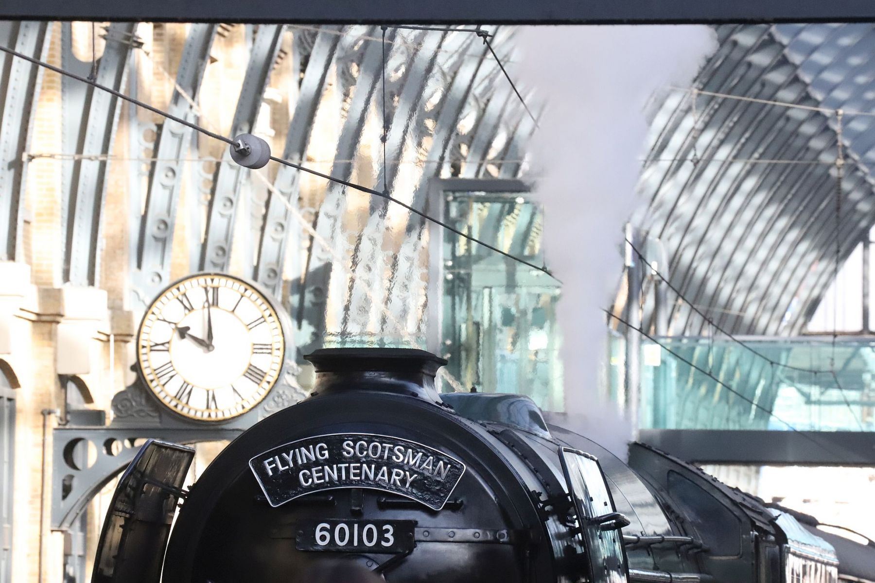 Flying Scotsman's whistle blows just before the 10:00am departure at King's Cross railway station platform 8