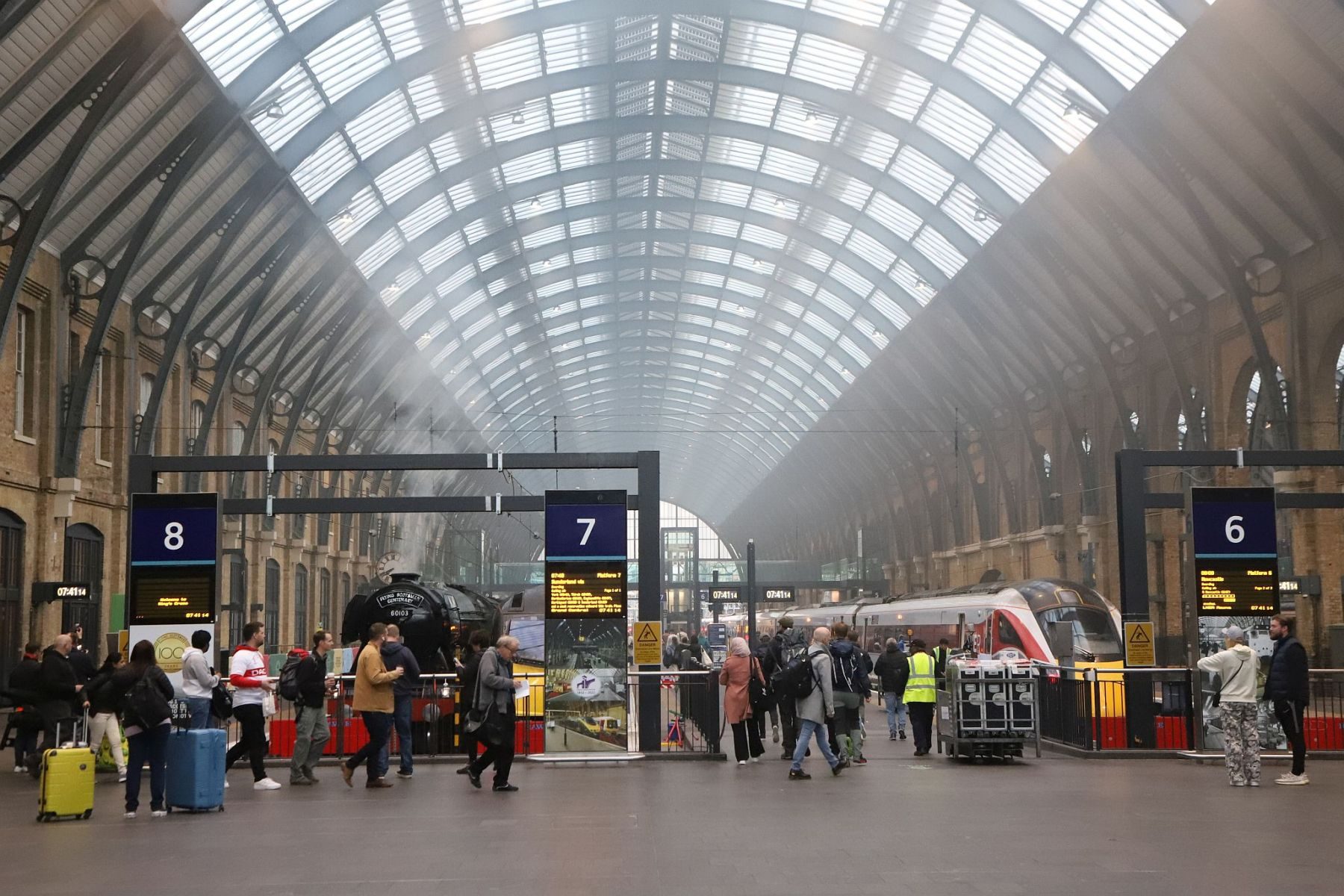 King's Cross train shed arched roof. Flying Scotsman steam locomotive at King's Cross railway station platform 8 for the 170th anniversary of the station's opening and the start of Flying Scotsman's 100th birthday celebrations