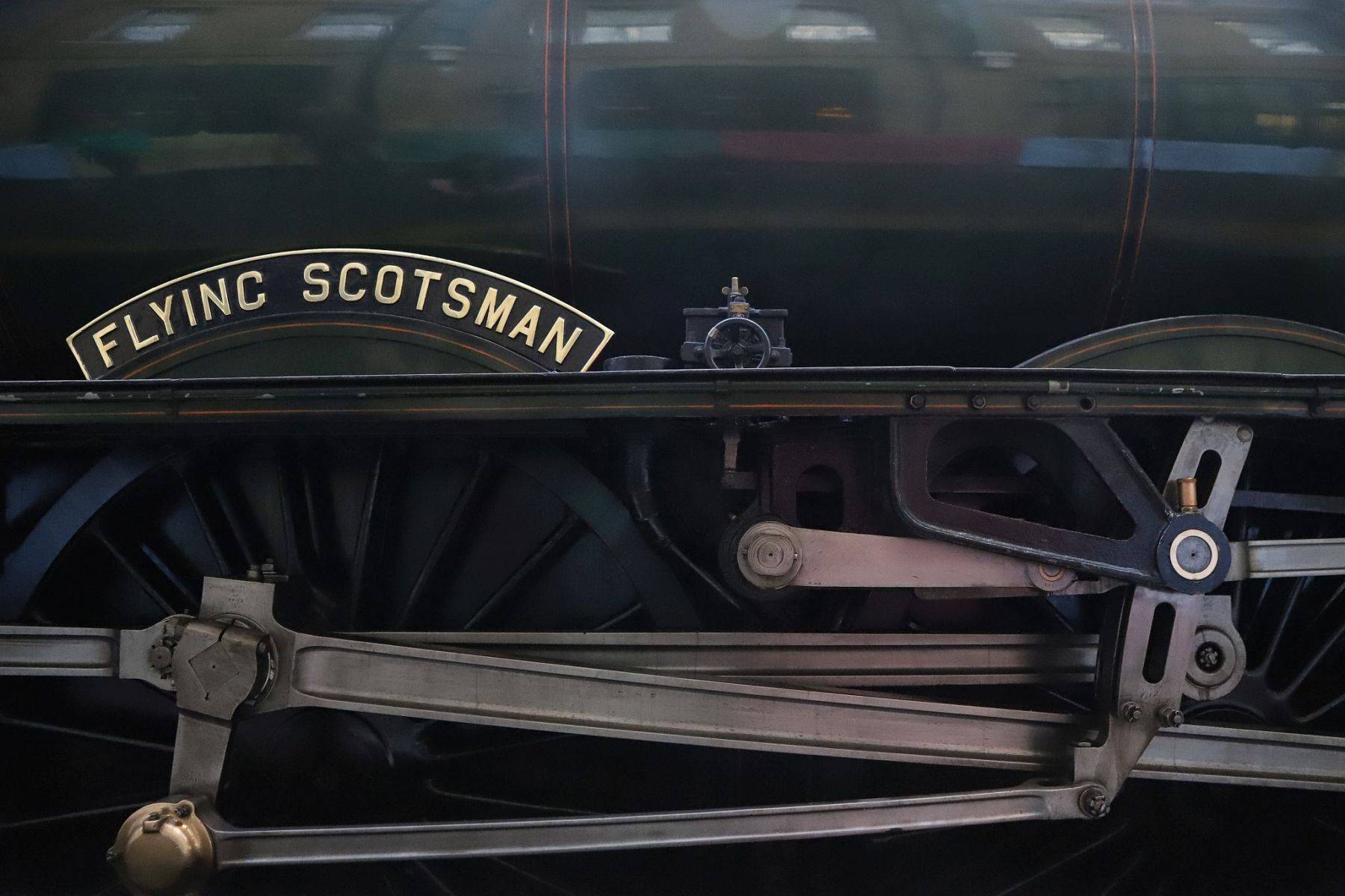 The nameplate, wheels and motion of Flying Scotsman. Flying Scotsman steam locomotive at King's Cross railway station platform 8 for the 170th anniversary of the station's opening and the start of Flying Scotsman's 100th birthday celebrations