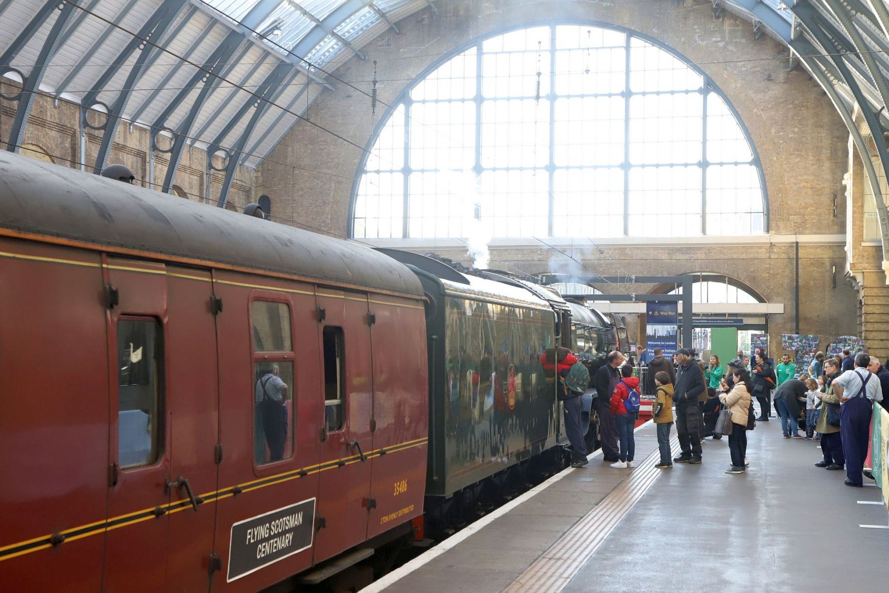 Flying Scotsman and support coach under the arched roof of the King's Cross train shed. Flying Scotsman steam locomotive at King's Cross railway station platform 8 for the 170th anniversary of the station's opening and the start of Flying Scotsman's 100th birthday celebrations