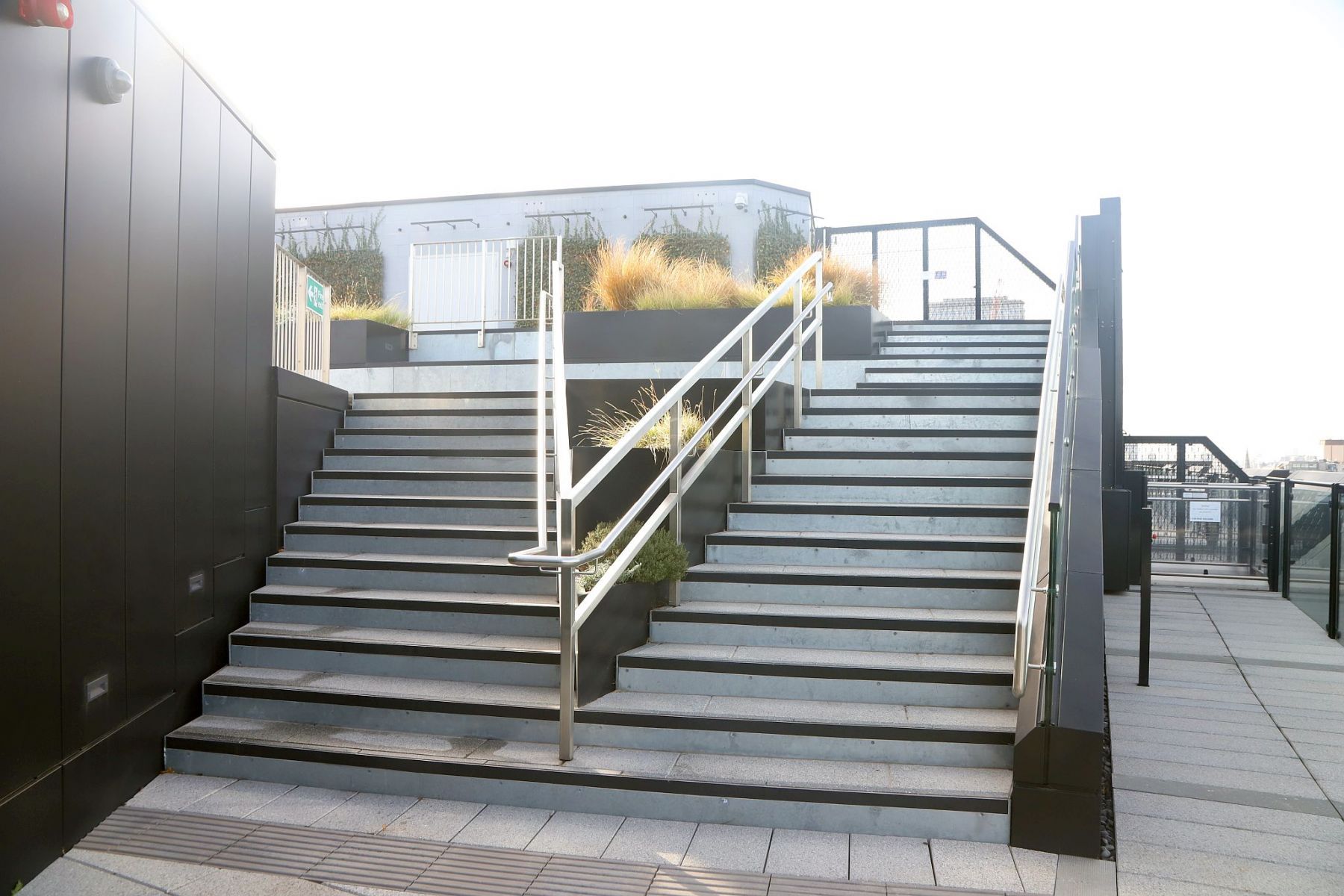 The steps up from the lift's exit to the Roof Garden at The Post Building in New Oxford Street. There is an accessible lift to the right.