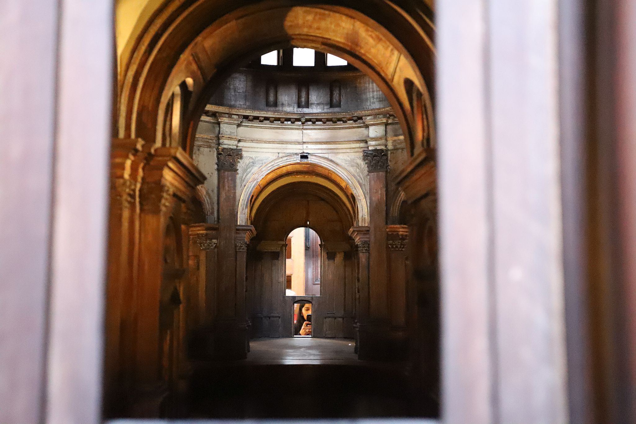 Inside the Great Model of a proposed design for St. Paul's Cathedral with a visitor looking in to take a photograph. St. Paul's Cathedral Triforium Tour, 09-Jan-2023.