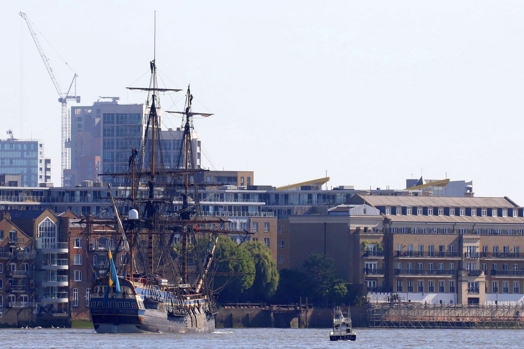 Sailing ship Götheborg of Sweden sailing downstream through London on the River Thames around the Rotherhithe Peninsular