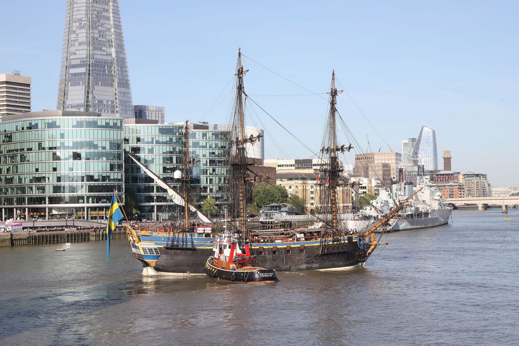 Sailing ship Götheborg of Sweden is turned by tug Christine to head back through Tower Bridge