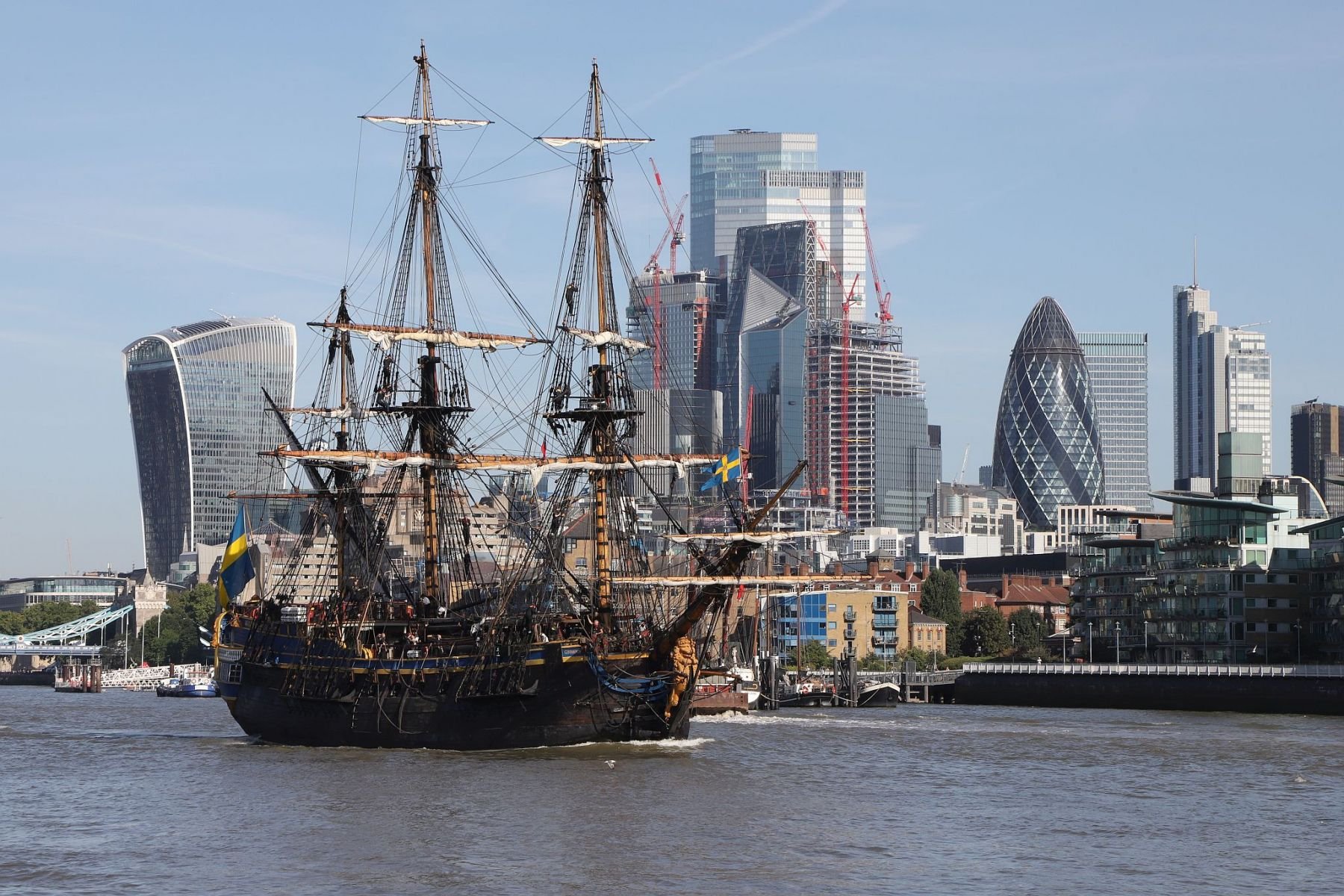 Sailing ship Götheborg of Sweden sailing  downstream through London on the River Thames from Tower Bridge, passing the City of London