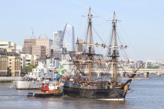 Sailing ship Götheborg of Sweden is turned by tug Christine to head back through Tower Bridge, London