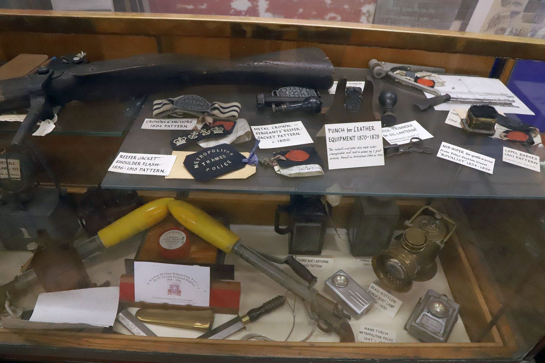 Cabinet of artefacts at the Metropolitan Police Marine Policing Unit Museum, River Thames, London.
