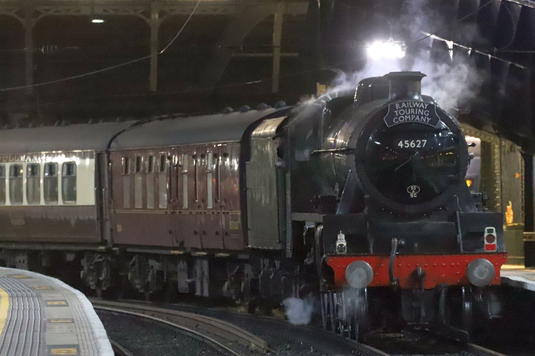 LMS Jubilee Class 5699/45699 Galatea at London Paddington railway station on the evening of 18-Feb-2023 with the Railway Touring Company's special train The Cotswold Venturer. Running as 45627 "Sierra Leone" with 45562 painted on the cab side.
