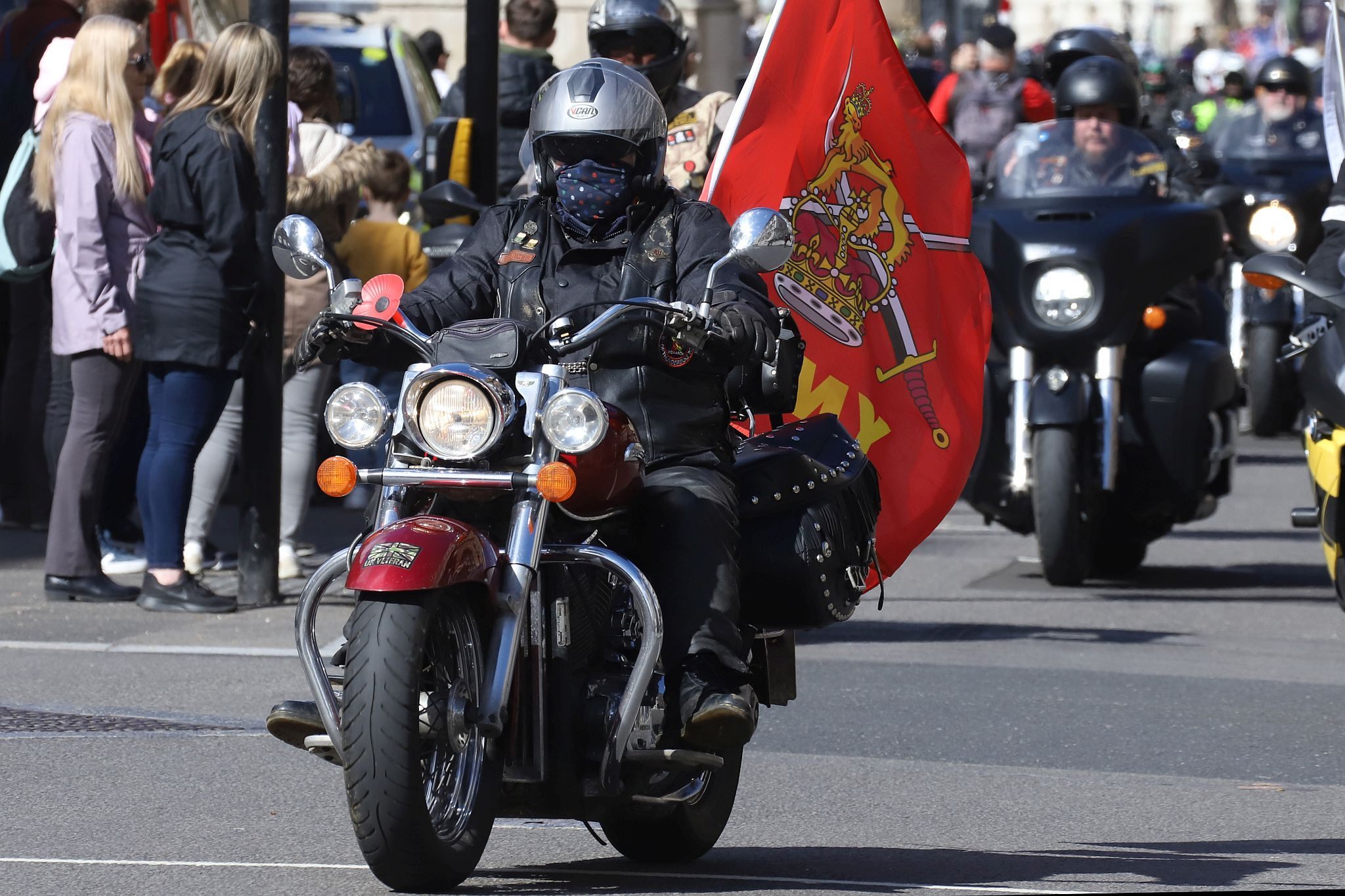 The Rolling Thunder UK military veterans motorcycle Ride of Respect, in memory of the late HM Queen Elizabeth II. 7th April 2023, Good Friday. Photographed in Whitehall, Westminster, London passing The Cenotaph war memorial and 10 Downing Street. Armed forces veterans. British Army flag.