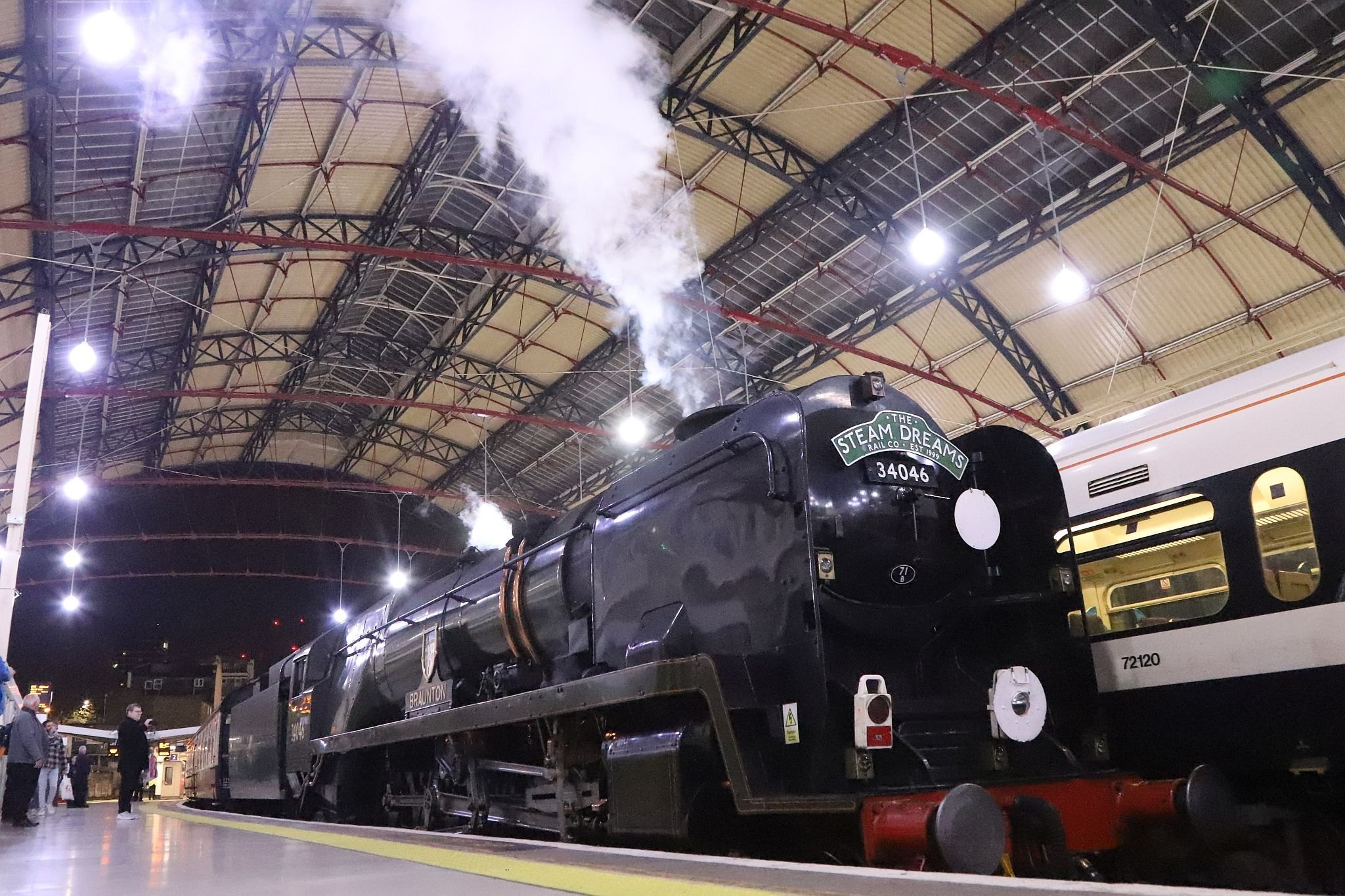 Southern Railway West Country class steam railway engine 34046 "Braunton" at platform 2 of London Victoria railway station on the night of Saturday 22nd April 2023, having worked the Steam Dreams special to Winchester and back.