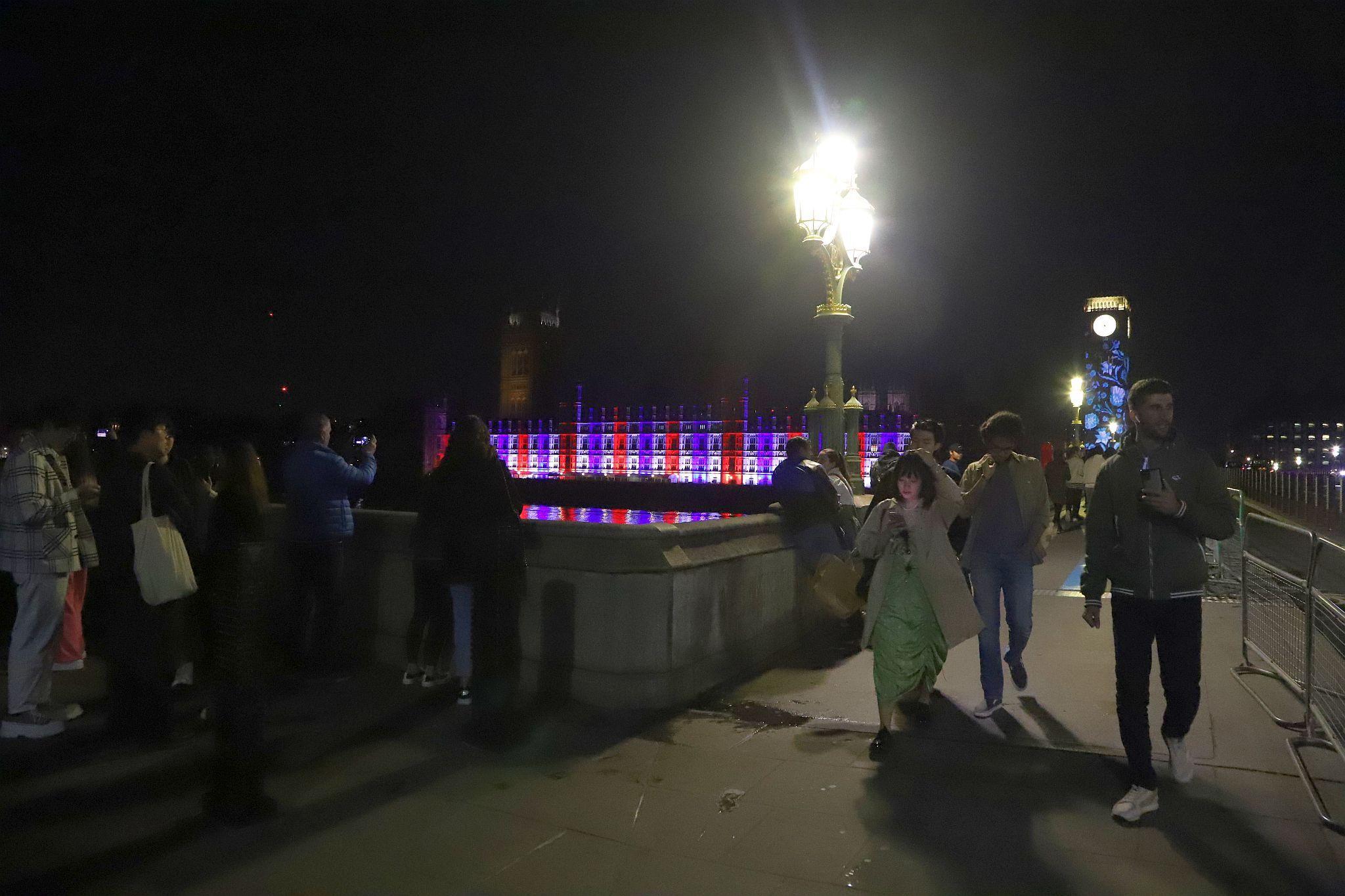 The Houses of Parliament lit red, white and blue to mark the Coronation of King Charles III and Queen Camilla. Photo taken 07-May-2023. London.