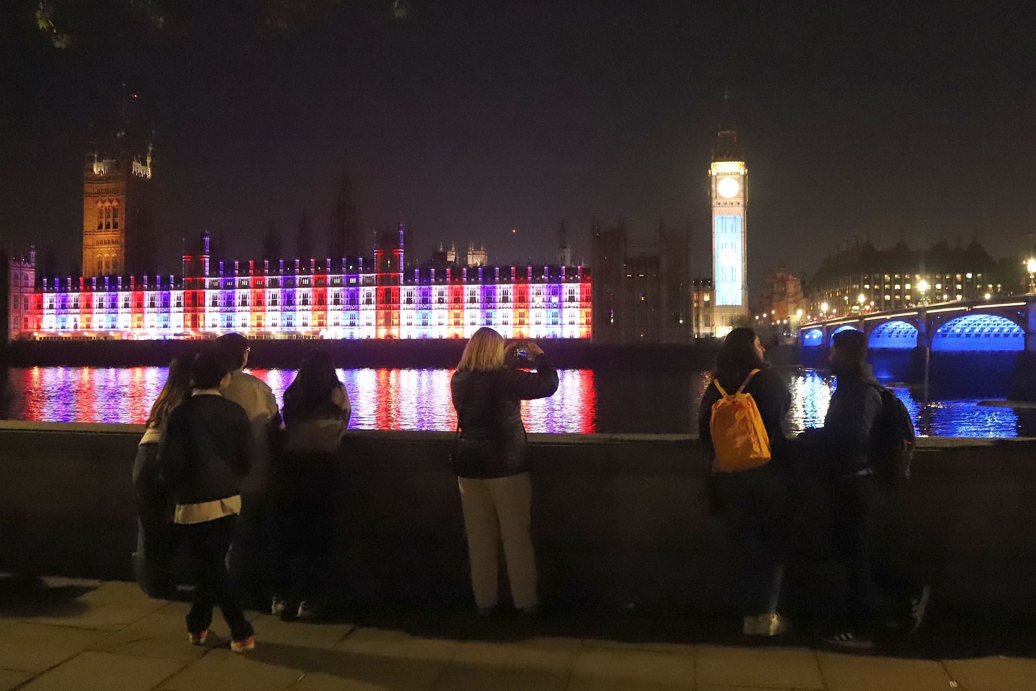 The Houses of Parliament lit red, white and blue to mark the Coronation of King Charles III and Queen Camilla. Photo taken 07-May-2023. London.