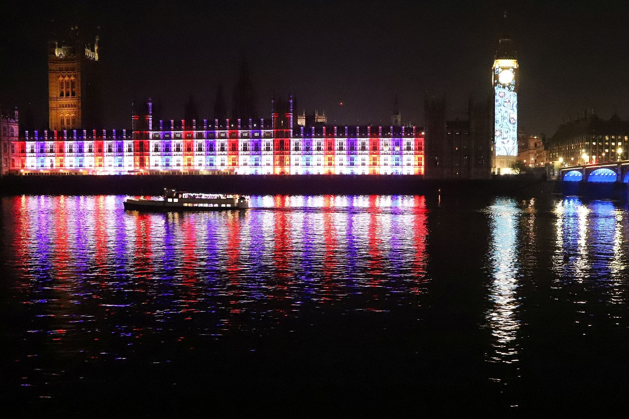 The Houses of Parliament lit red, white and blue to mark the Coronation of King Charles III and Queen Camilla. Photo taken 07-May-2023. London.