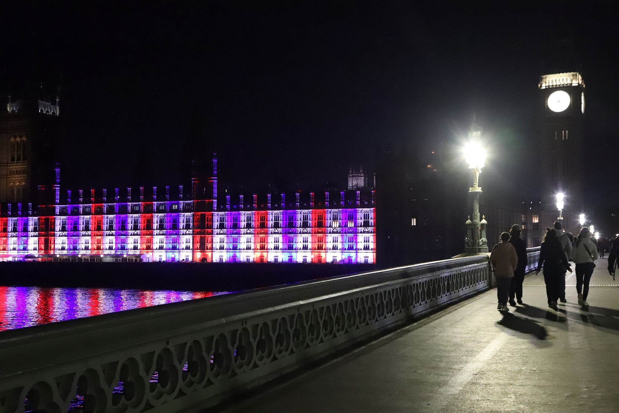 The Houses of Parliament lit red, white and blue to mark the Coronation of King Charles III and Queen Camilla. Photo taken 07-May-2023. London.