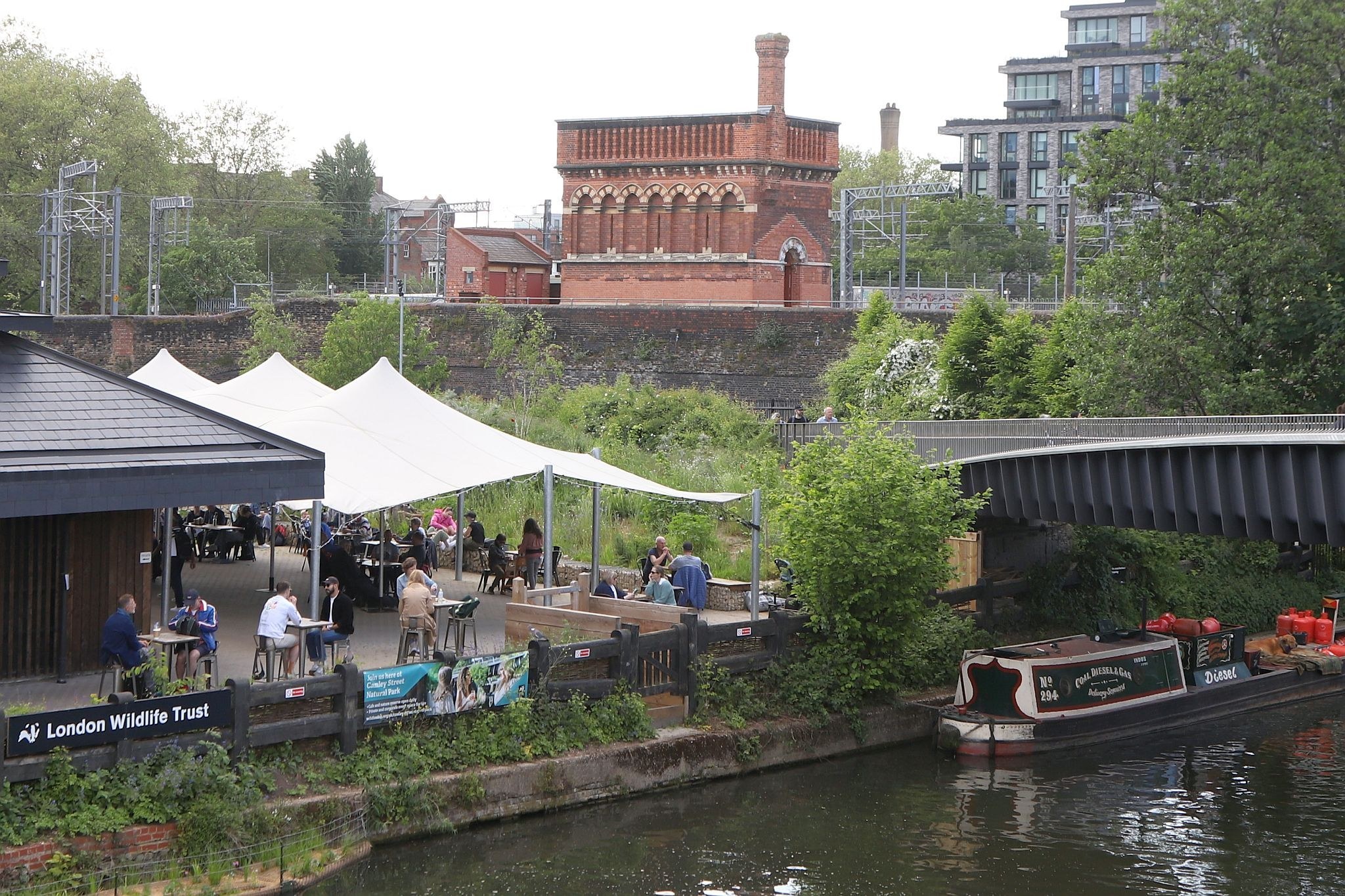 Looking across the Camley Street Natural Park to the St Pancras waterpoint. Water tower. King's Cross. Coal Drops Yard. Regents Canal. 20-May-2023.