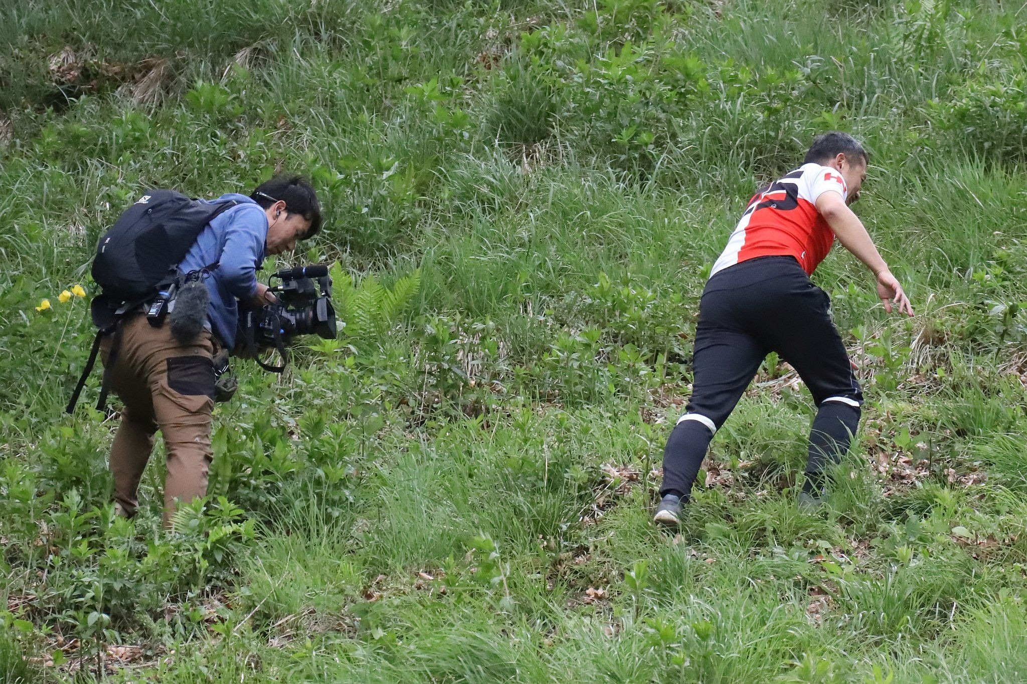TV/Japanese film crew. Coopers Hill Cheese Rolling Race. 29-May-2023. Race downhill. Gloucestershire tradition.