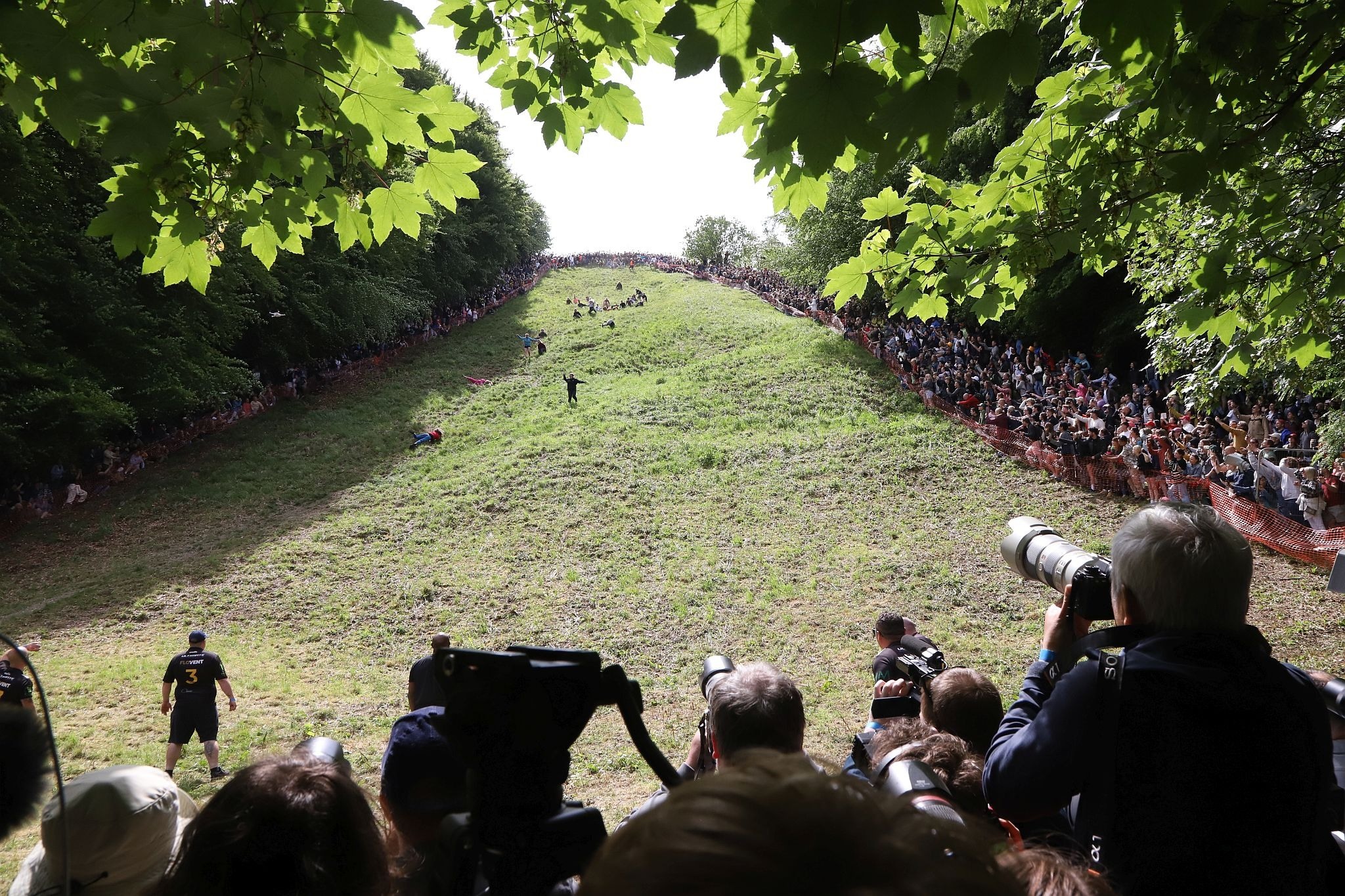 TV/Film crews in the press pen. Coopers Hill Cheese Rolling Race. 29-May-2023. Race downhill. Gloucestershire tradition.
