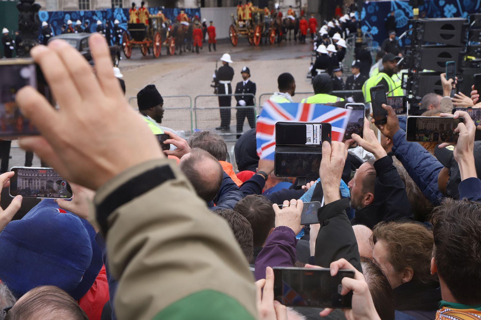 Defying the forecast rain, large numbers ensured their were crowds of spectators along the route of the procession. As the parade passed a forest of selfie sticks were held up high to record the event. 06-May-2023.