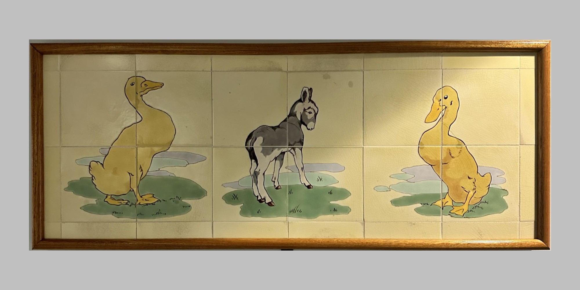 Animal scenes painted on Doulton tiles from the Evelina Children's Hospital displayed in a corridor of St Thomas' hospital.