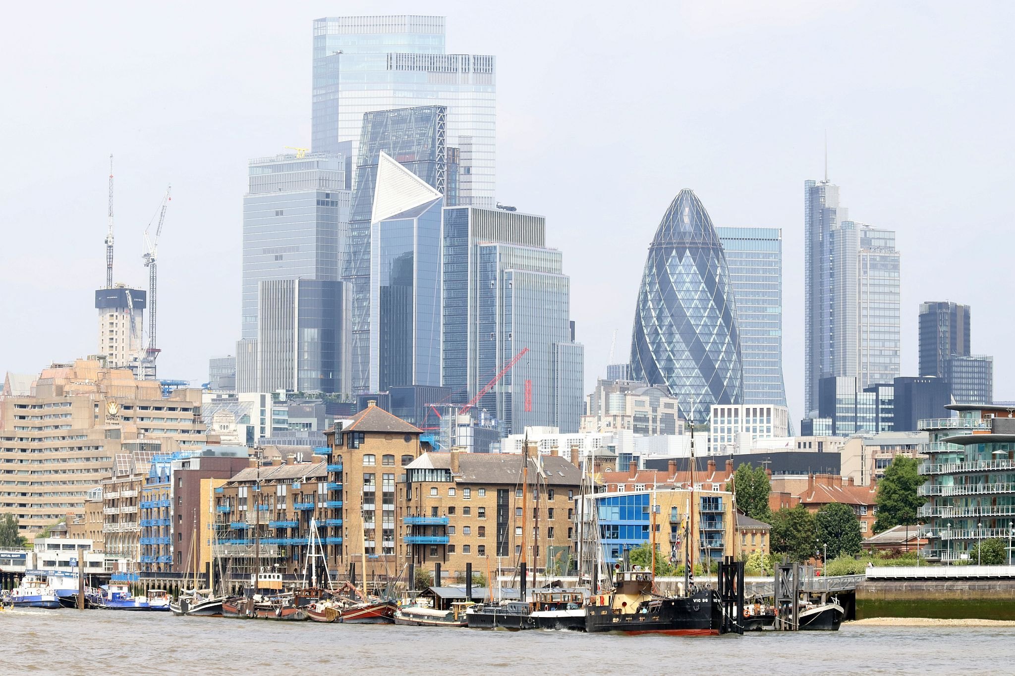 VIC 96 tied up alongside Hermitage Moorings in central London by Tower Bridge with the City of London behind. Steam powered ship VIC 96 visited central London in June 2023.