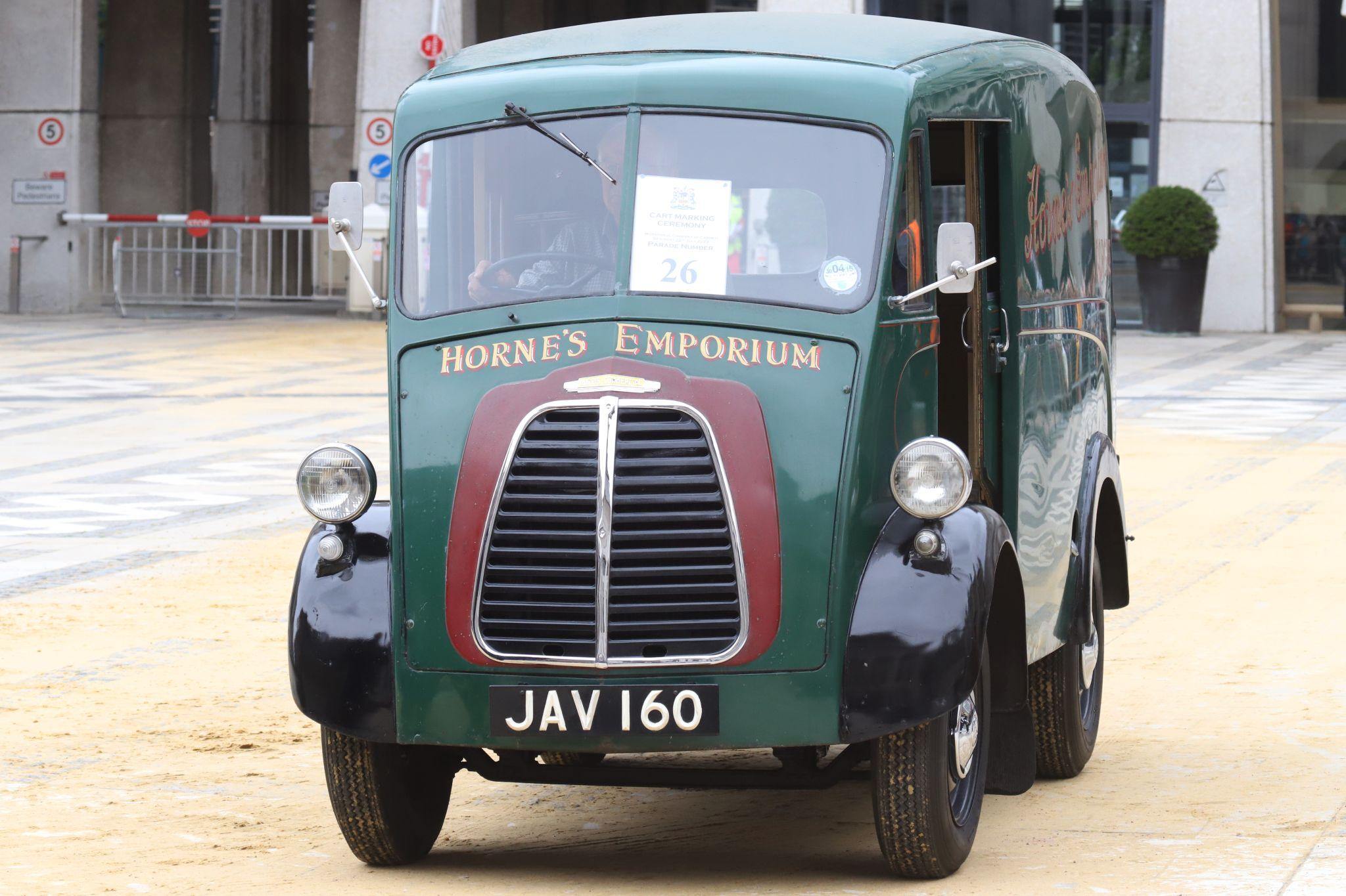 Morris J Type 1955 JAV160. City of London 2023 Cart Marking in Guildhall Yard on 22-Jul-2023. Hosted by the Worshipful Company of Carmen with the Lord Mayor of the City of London in attendance. Wooden plates on the vehicles are branded with hot irons to allow them to ply for trade in the Square Mile. Another of the City Livery Company's annual ceremonies.