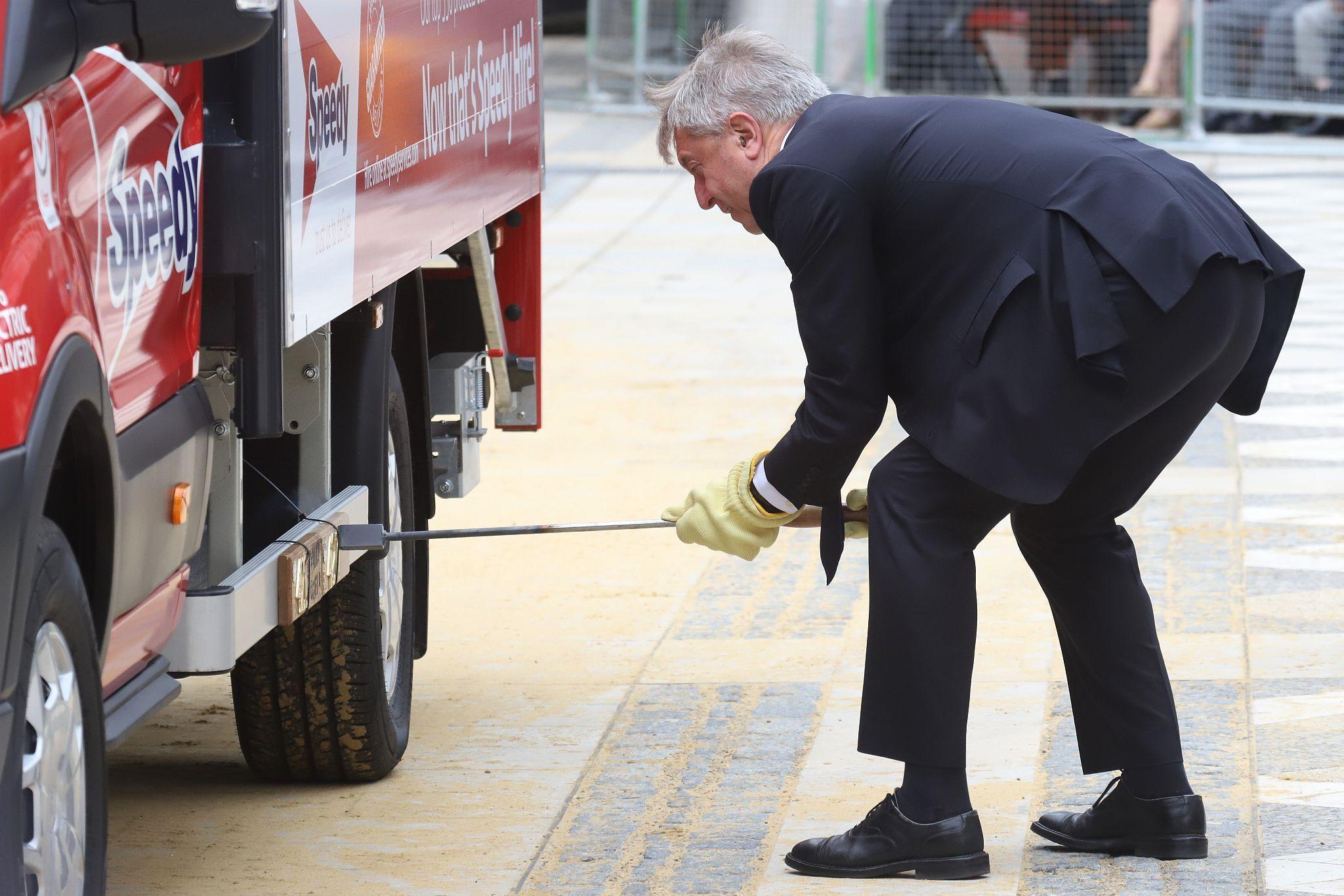 Graham Cole, best known for playing PC Tony Stamp in "The Bill", brands a registration plate on one of the exhibits. City of London 2023 Cart Marking in Guildhall Yard on 22-Jul-2023. Hosted by the Worshipful Company of Carmen with the Lord Mayor of the City of London in attendance. Wooden plates on the vehicles are branded with hot irons to allow them to ply for trade in the Square Mile. Another of the City Livery Company's annual ceremonies.