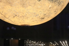 The lights leading to the Town Hall entrance in the background. Luke Jerram's "Mars: War and Peace" on display in Jubilee Square outside Kensington and Chelsea Town Hall, and the Central Library. Mars was on display as part of the 2023 Kensington and Chelsea Festival. Photo taken 11-Aug-2023. https://bryan-jones.com