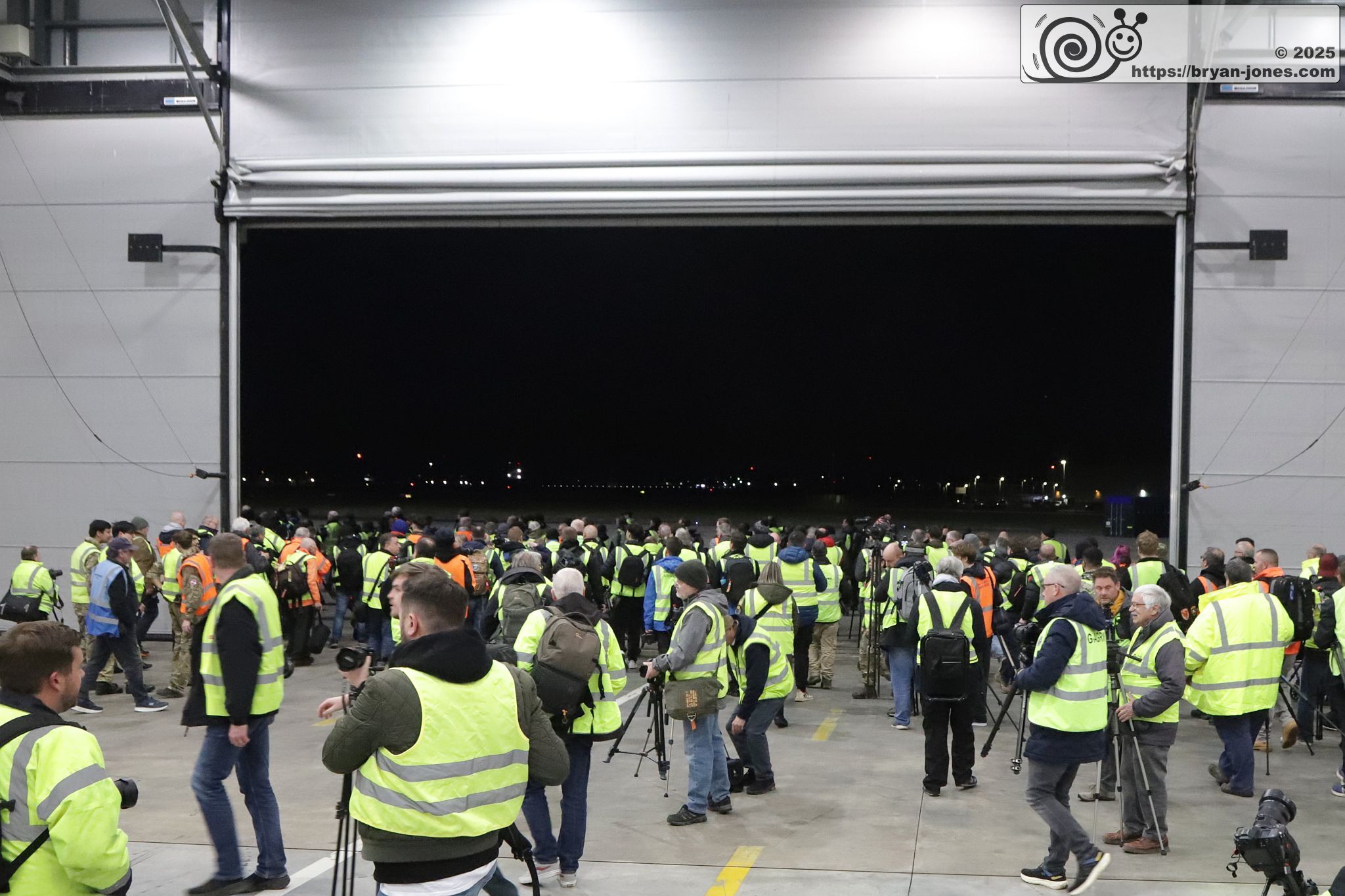 Photographers exit RAF Northolt hangar on to apron. 06-Mar-2025.