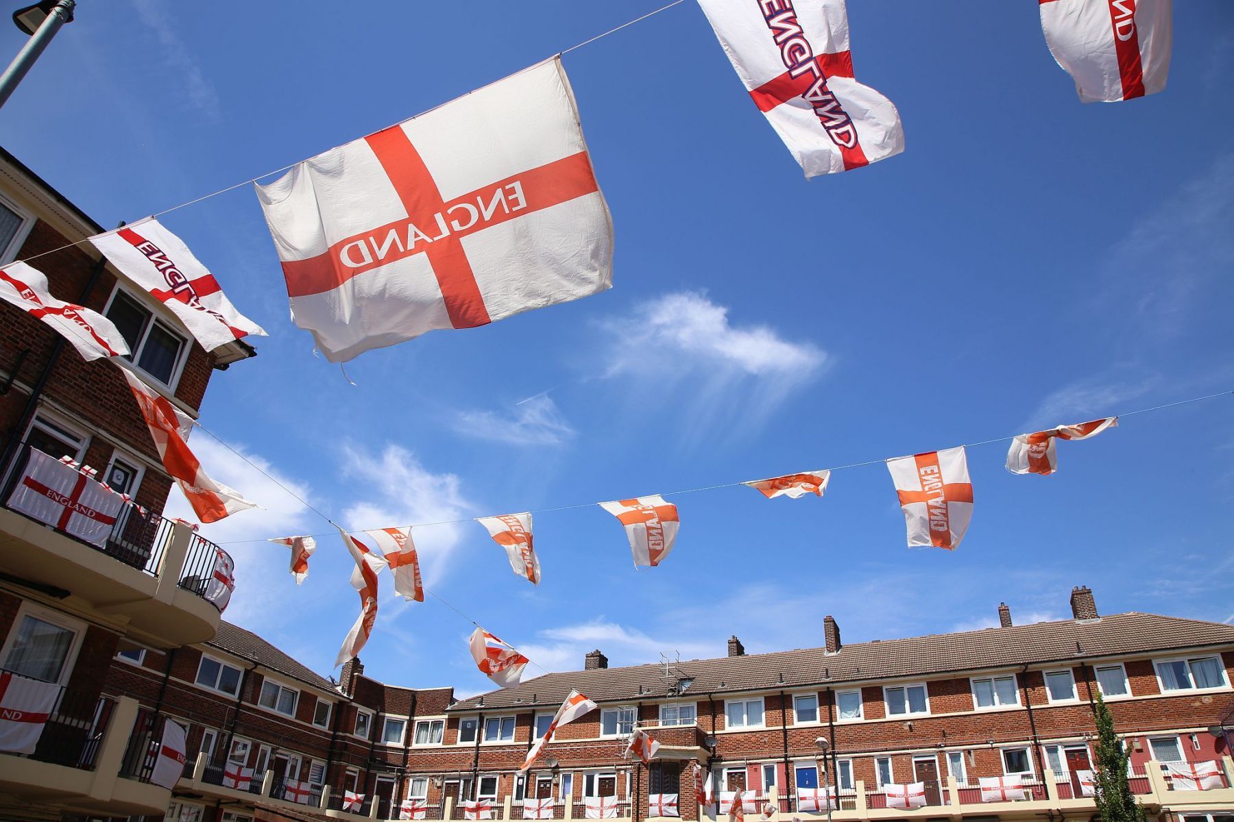 England flags flying from the flat's balconies and strung between lampposts on the Kirby Estate in Bermondsey, SE London