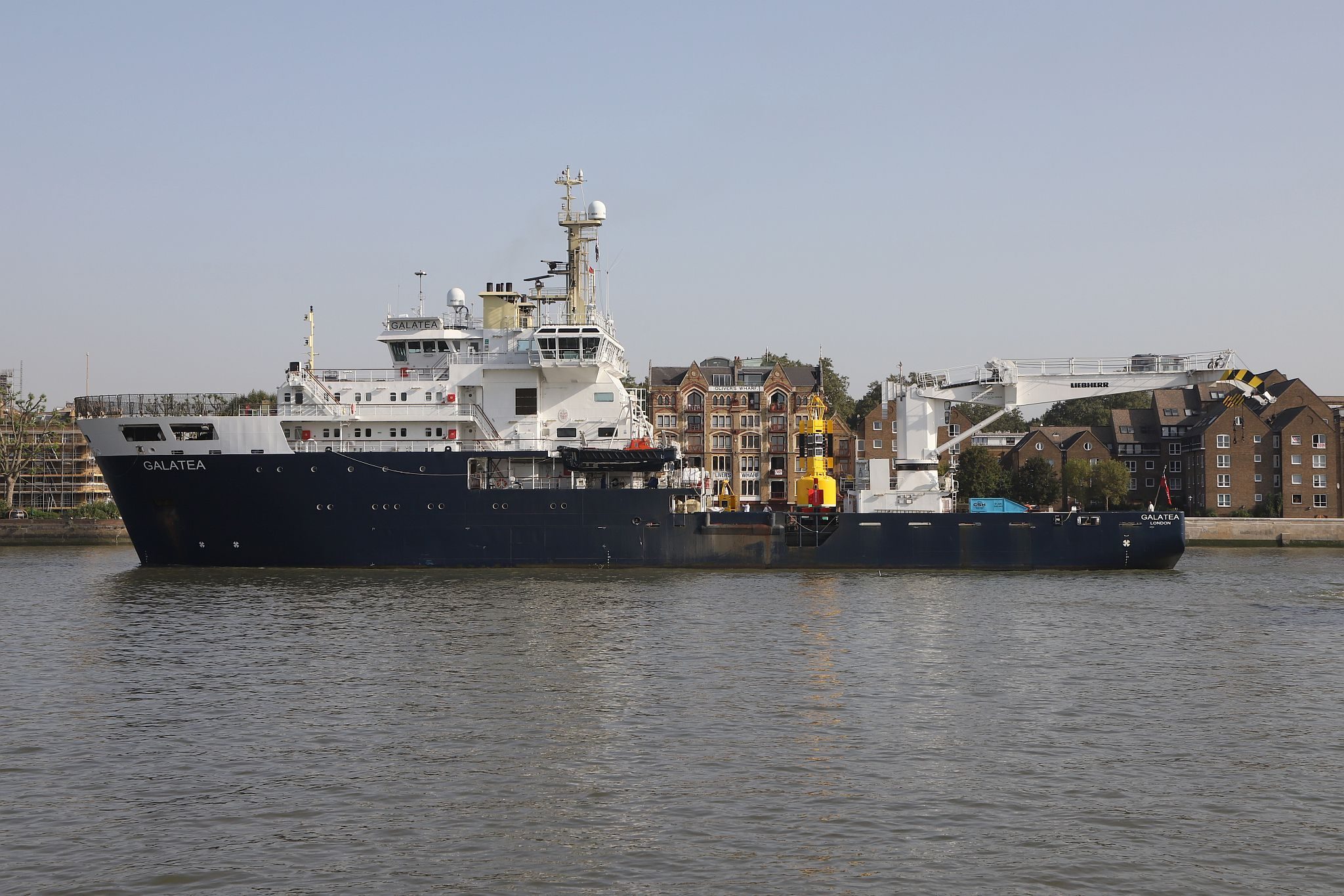 Trinity House Vessel Galatea sailing up the River Thames past Wapping towards the Pool of London.