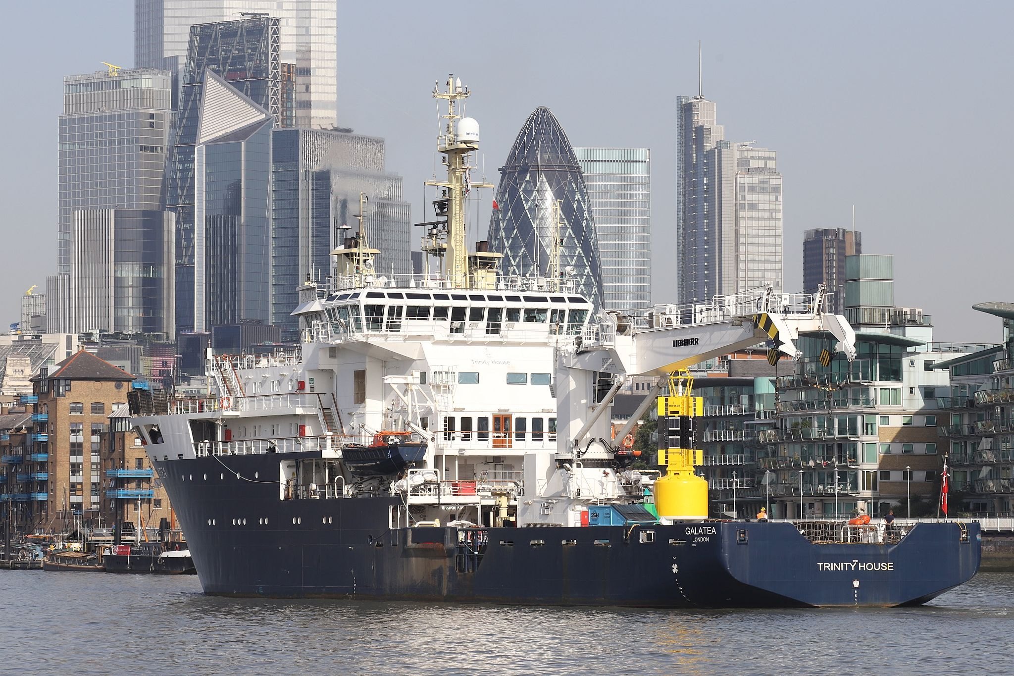 Trinity House Vessel Galatea sailing up the River Thames past Wapping and the City of London towards the Pool of London. 09-Sep-2023.