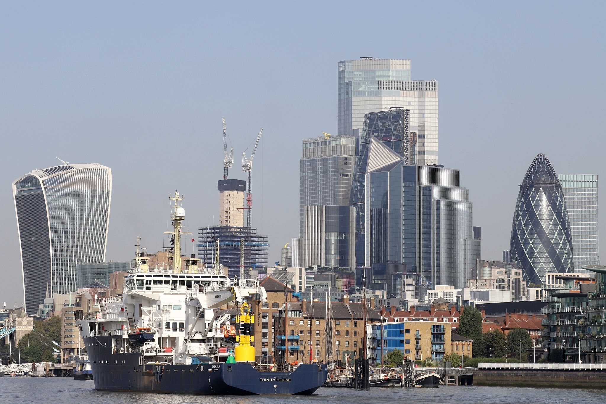 Trinity House Vessel Galatea sailing up the River Thames past Wapping and the City of London towards the Pool of London. 09-Sep-2023.