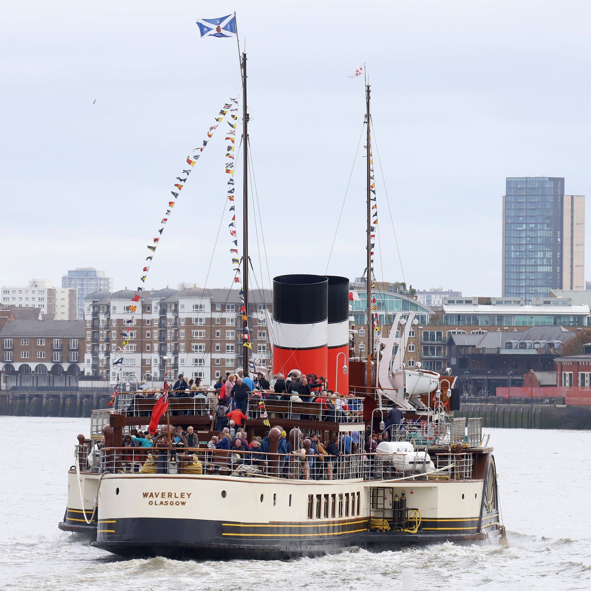Paddle Steamer Waverley sails down the River Thames towards the sea. 24-Sep-2023. Rotherhithe in the background.