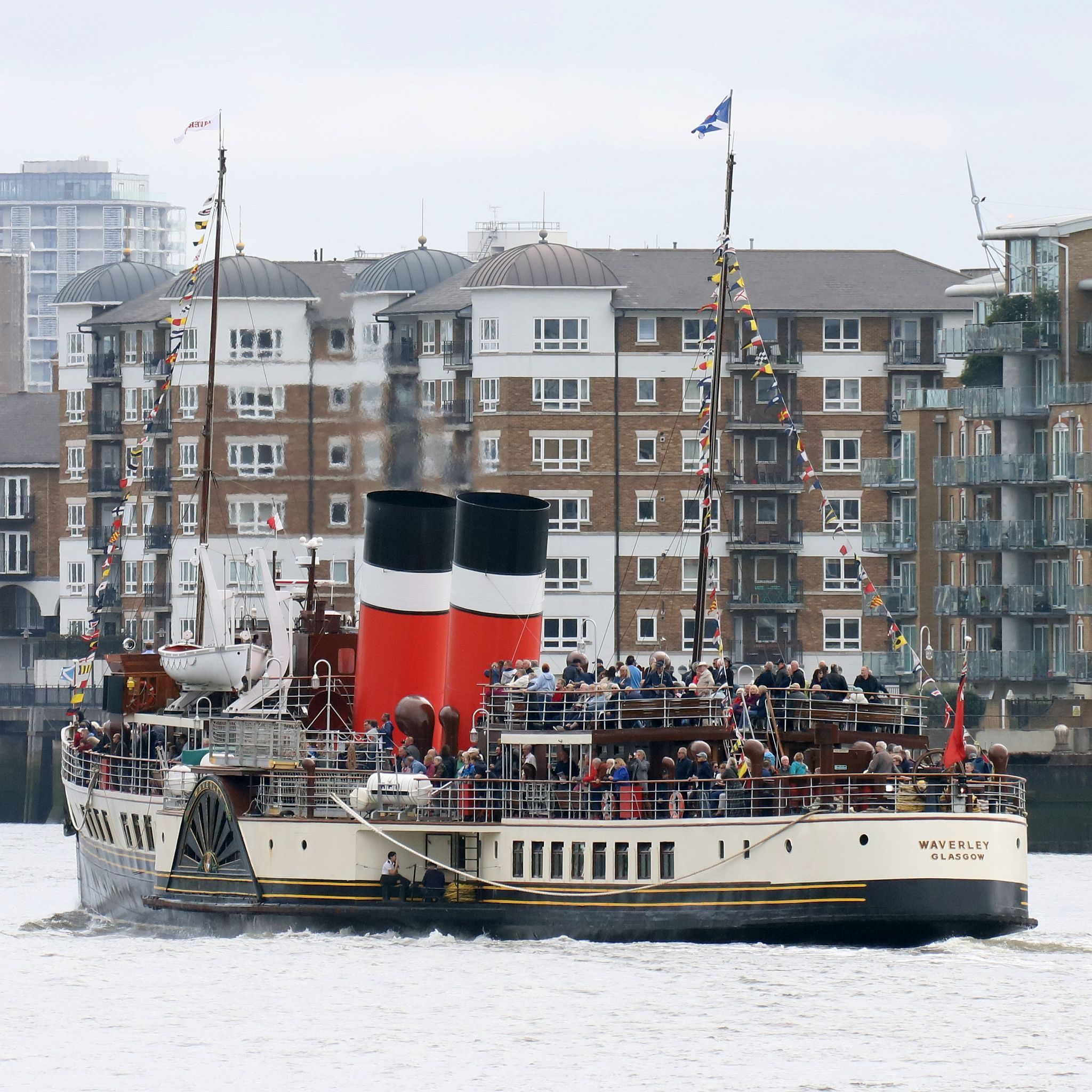 Paddle Steamer Waverley sails down the River Thames towards the sea. 24-Sep-2023. Rotherhithe in the background.