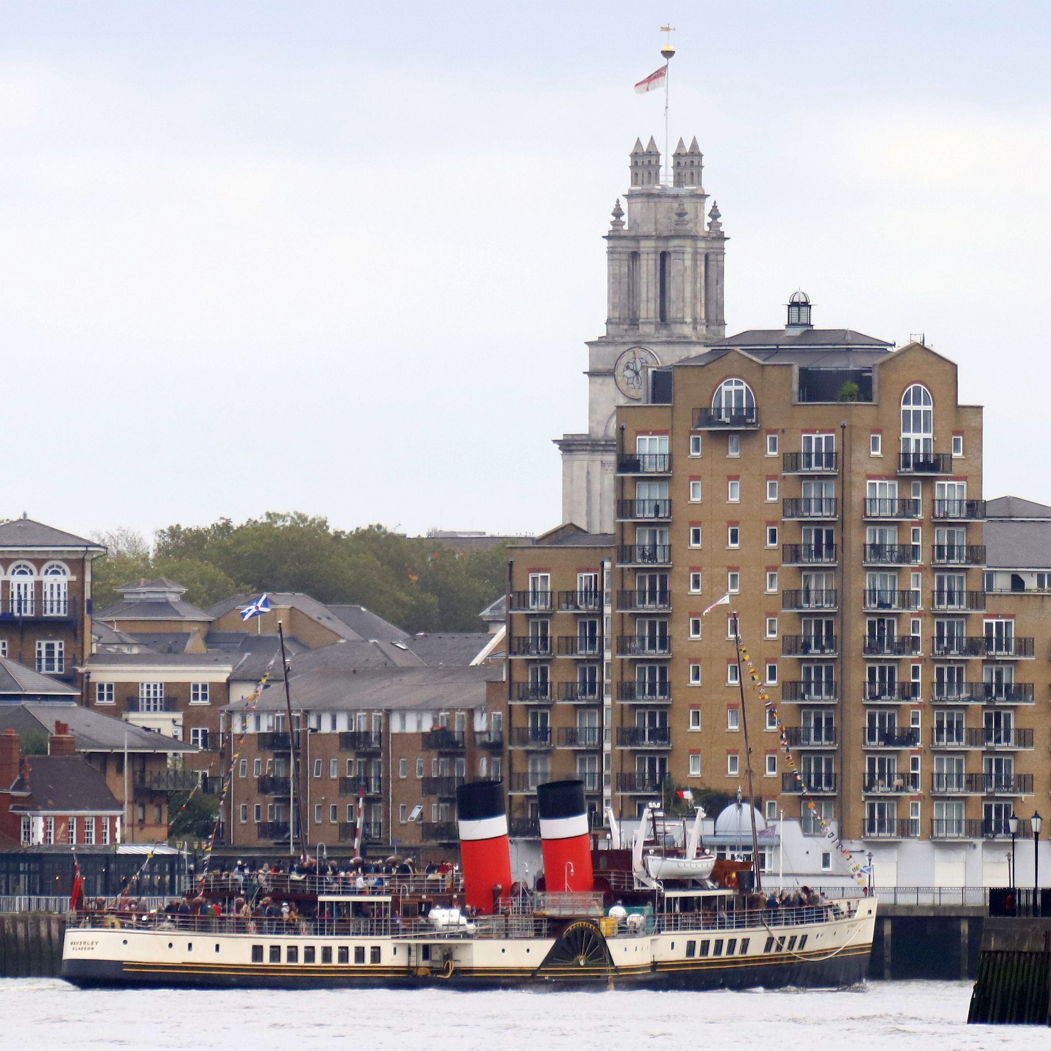 Paddle Steamer Waverley sails down the River Thames towards the sea. 24-Sep-2023. St Mary's Limehouse in the background.