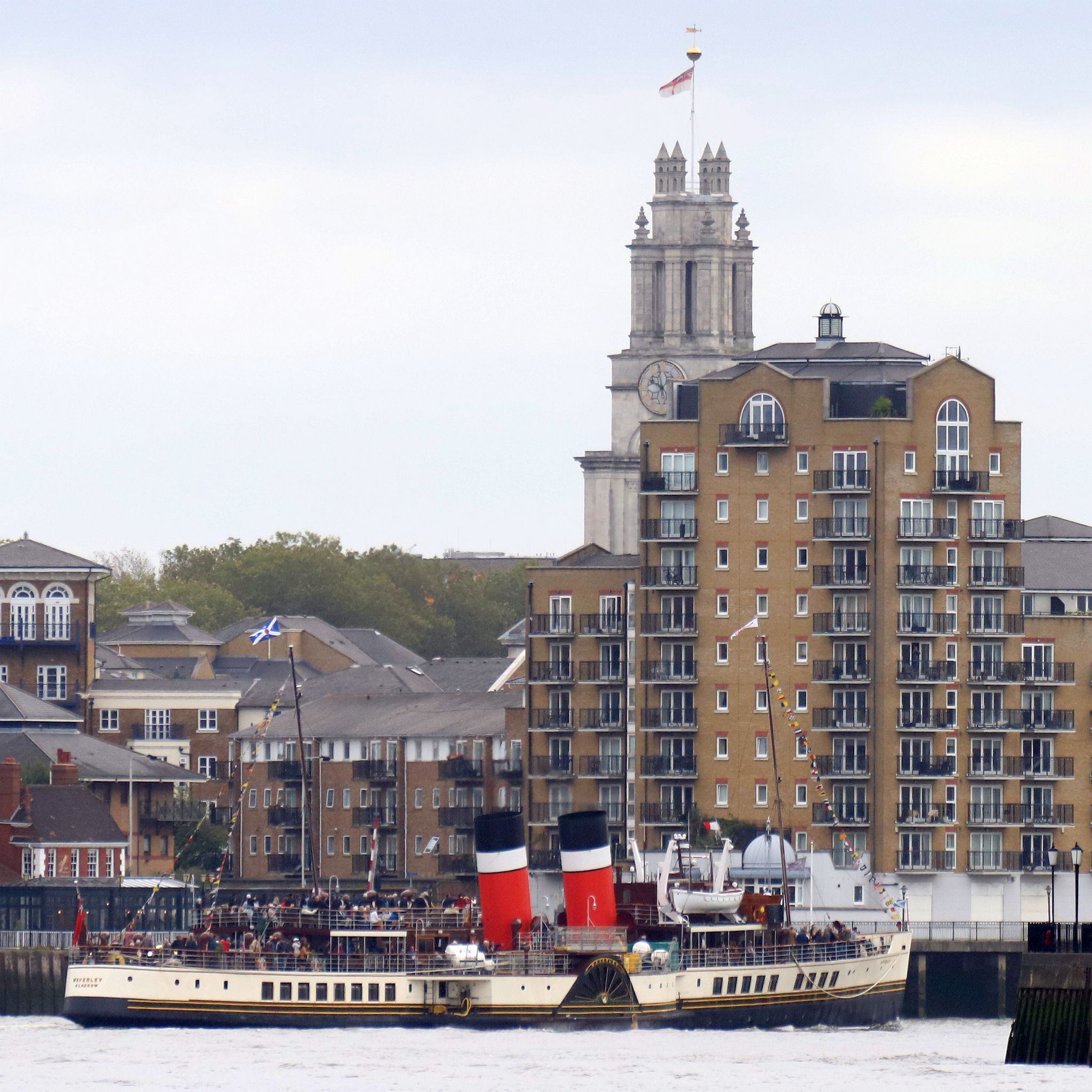 Paddle Steamer Waverley sails down the River Thames towards the sea. 24-Sep-2023. St Mary\'s Limehouse in the background.