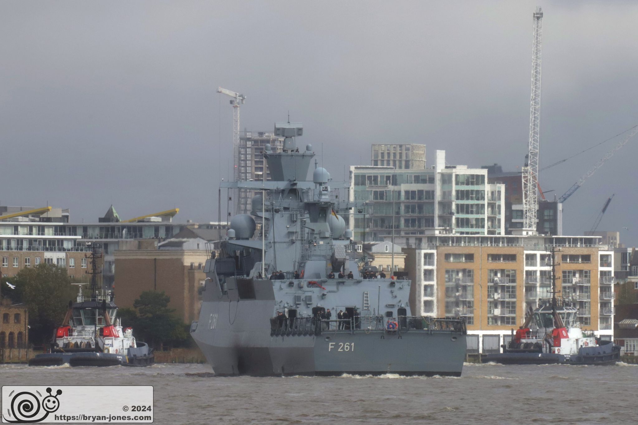 Tugs Peter and Ambition lead FGS Magdeburg on the River Thames