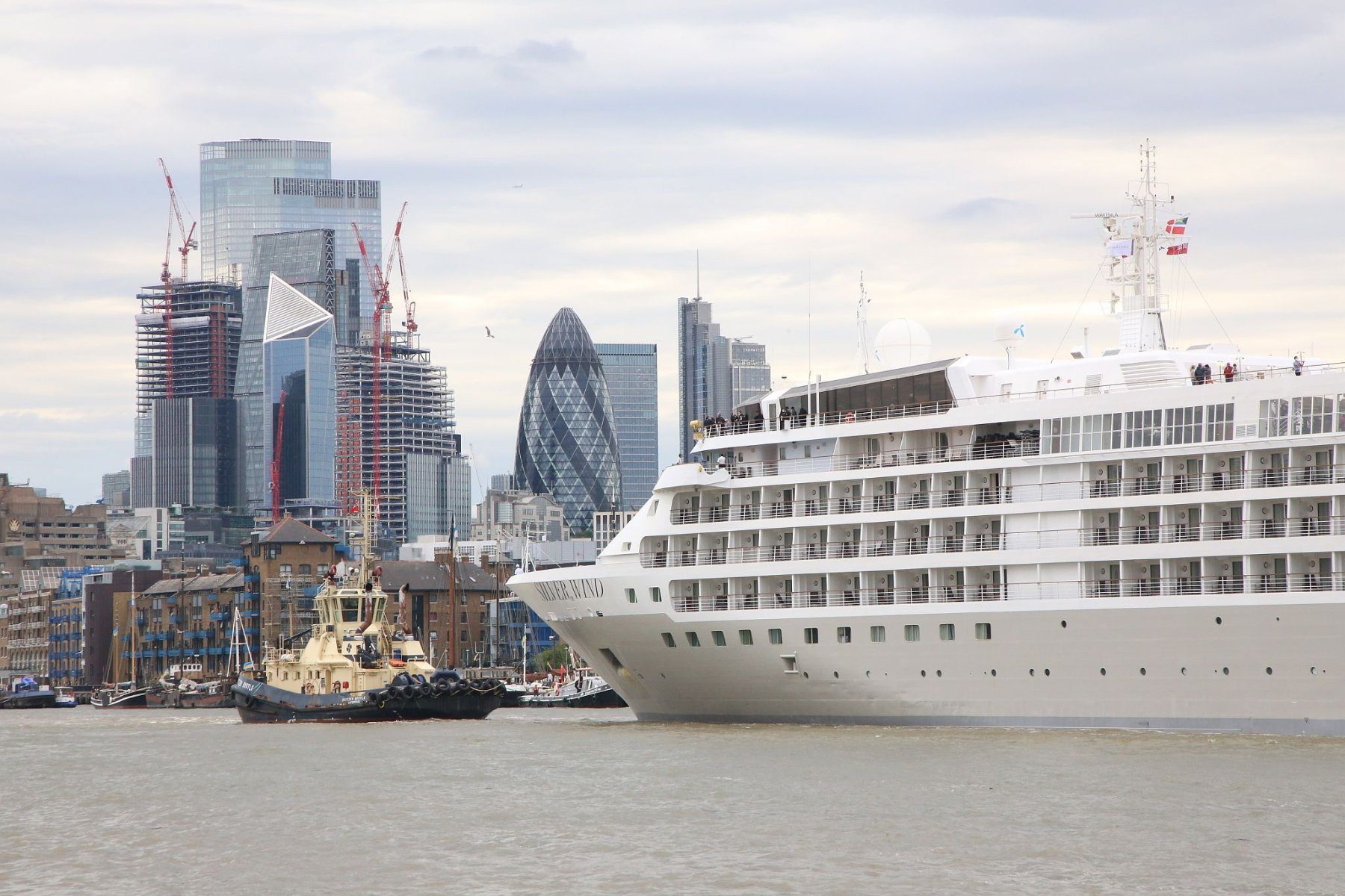 Cruise ship Silver Wind being taken backwards down the River Thames, before being turned at Wapping, to leaving London 19-Jun-2022