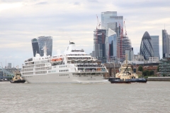 Cruise ship Silver Wind being taken backwards down the River Thames, before being turned at Wapping, to leaving London 19-Jun-2022