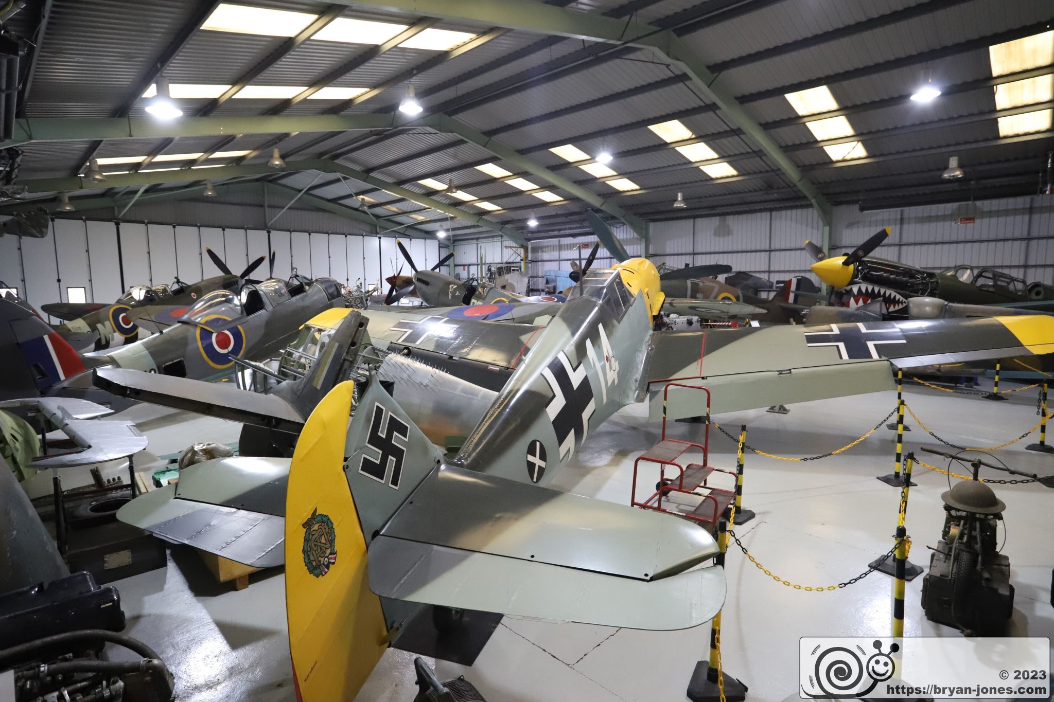 Hangar containing WW2 Spitfire and Bf 109 fighter aircraft